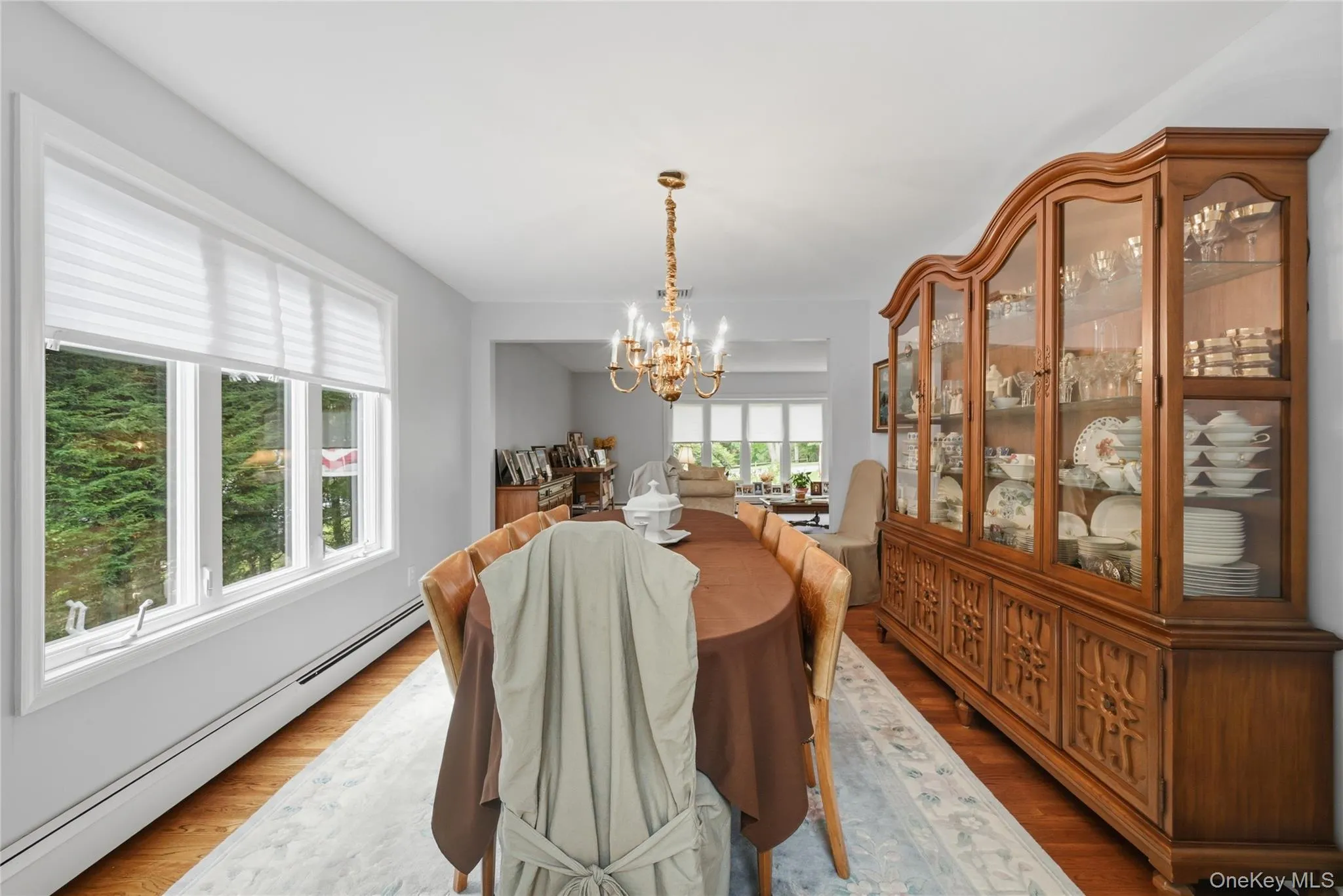 Formal dining - Hardwood flooring, and a brass chandelier with candelabra-style bulbs Formal dining - Hardwood flooring, and a brass chandelier with candelabra-style bulbs