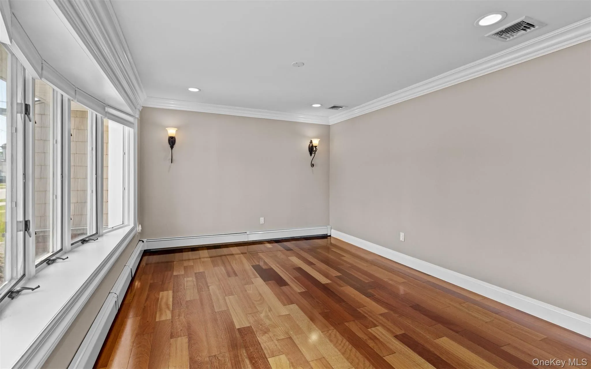 Cherry wood finish flooring, base and crown moldings, large bay window, recessed lighting Cherry wood finish flooring, base and crown moldings, large bay window, recessed lighting