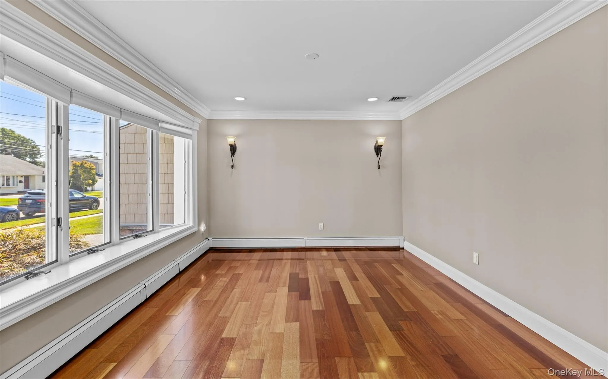 Cherry wood finish flooring, base and crown moldings, large bay window, recessed lighting Cherry wood finish flooring, base and crown moldings, large bay window, recessed lighting