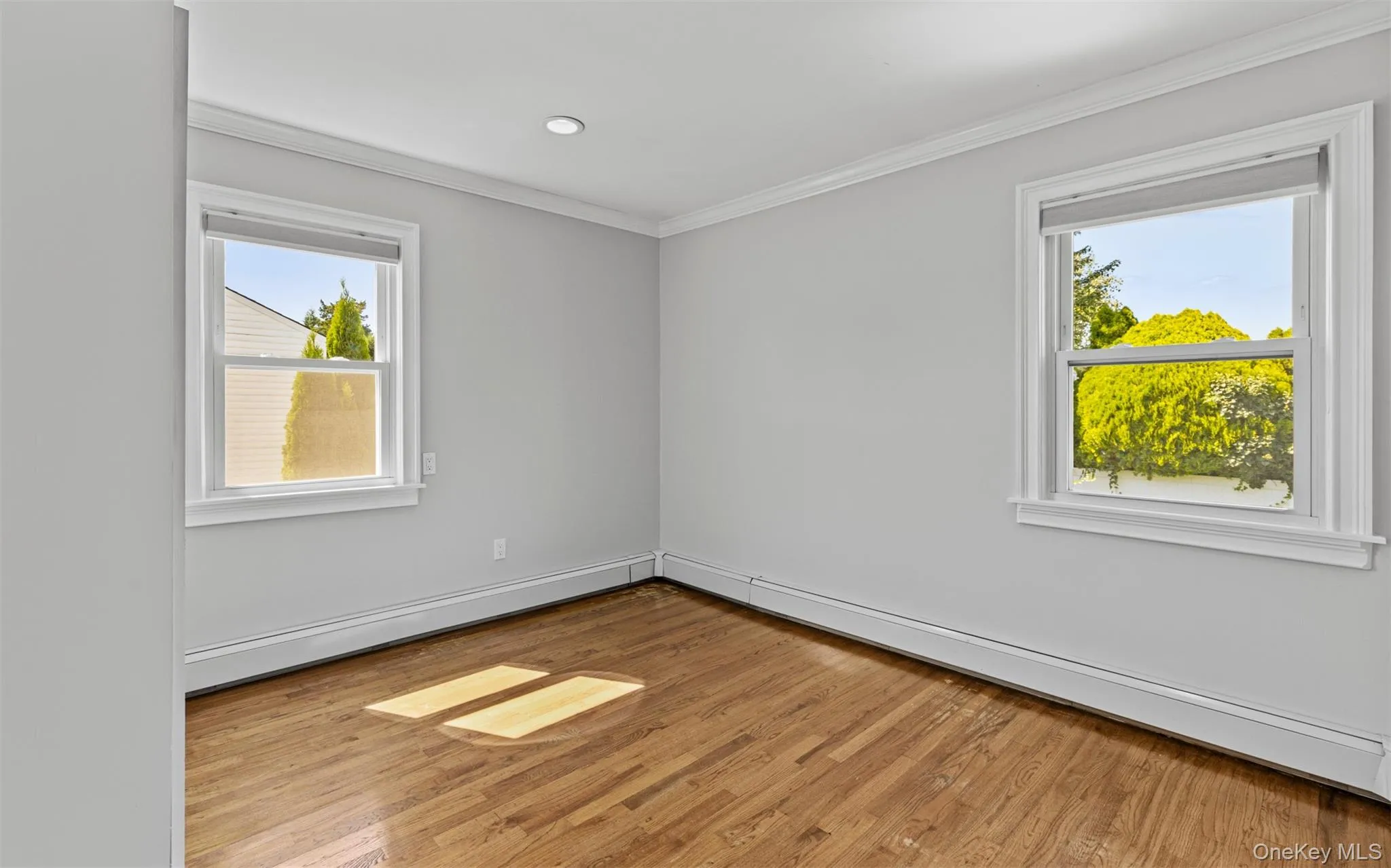 Wood-finish flooring, recessed lighting, and crown molding Wood-finish flooring, recessed lighting, and crown molding