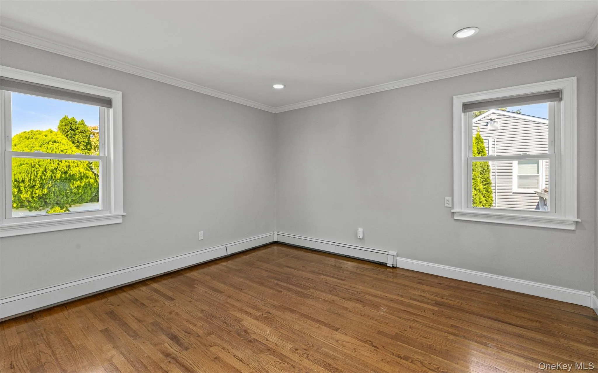 Hardwood flooring, crown molding, recessed lighting, and dual windows Hardwood flooring, crown molding, recessed lighting, and dual windows
