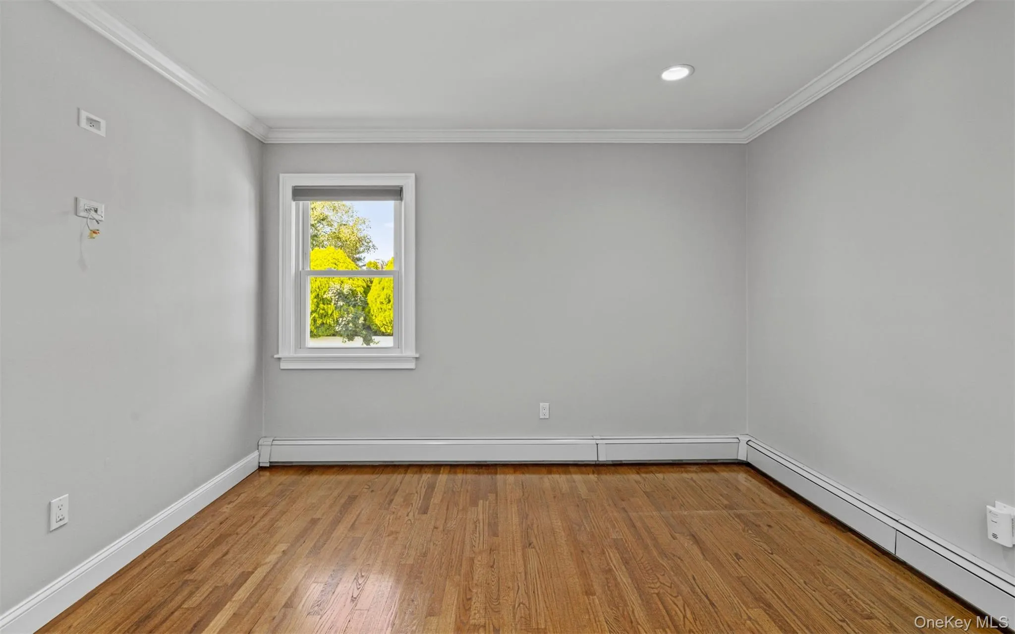 Hardwood flooring, recessed ceiling lighting, crown molding, double-hung window, and baseboard heating Hardwood flooring, recessed ceiling lighting, crown molding, double-hung window, and baseboard heating