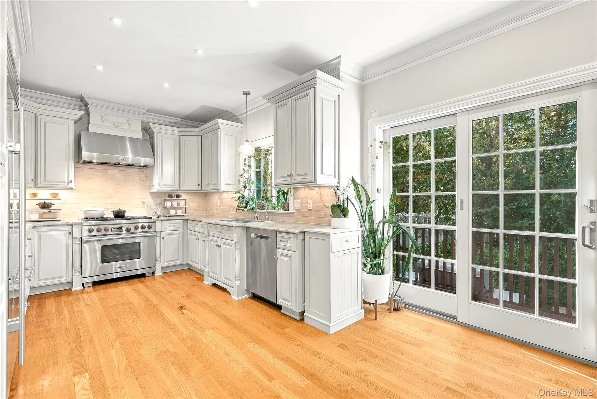 Spacious Chef's Kitchen with Stainless appliances & Sliding Glass Doors to Backyard and Patio Area Spacious Chef's Kitchen with Stainless appliances & Sliding Glass Doors to Backyard and Patio Area