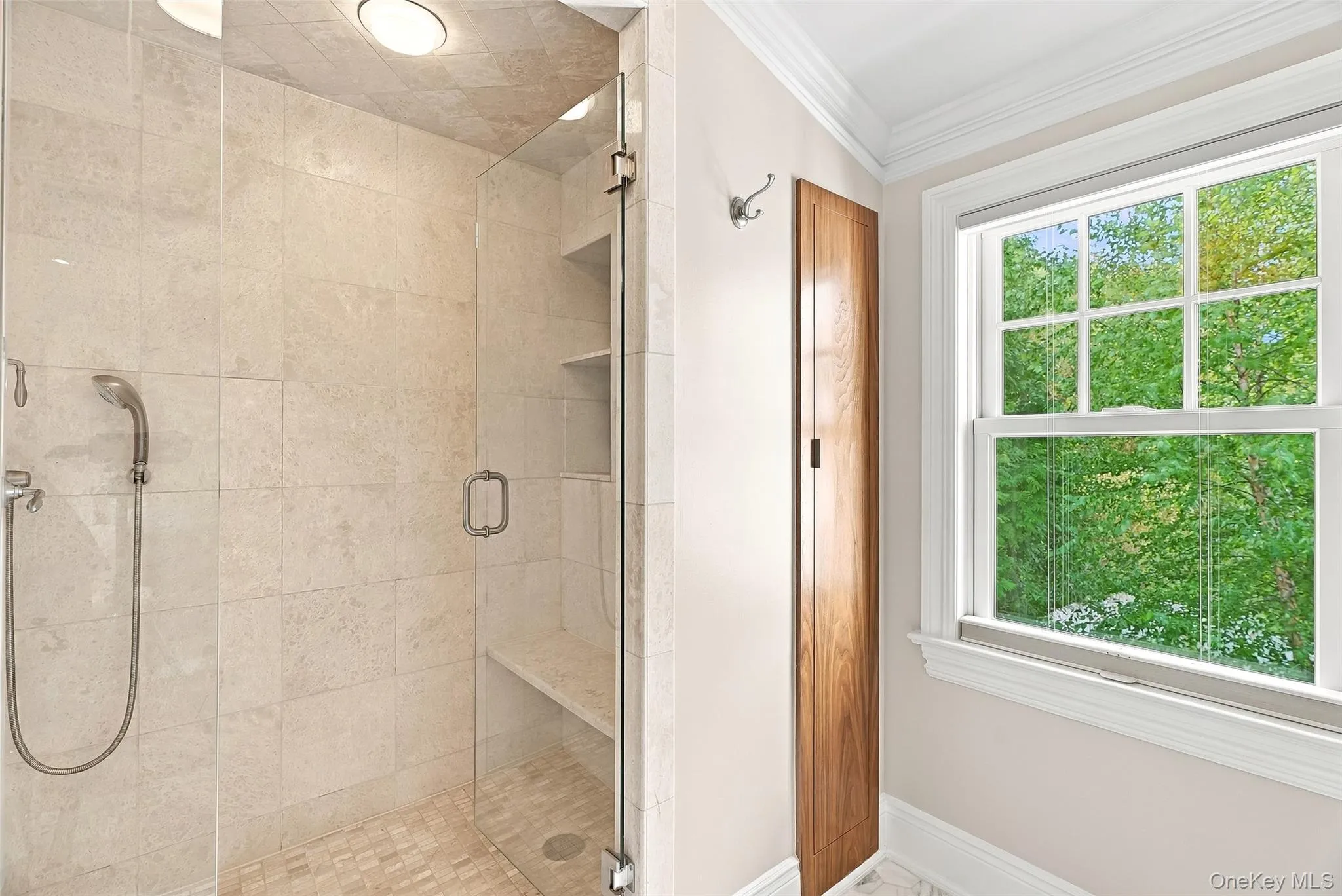 Primary Ensuite Bath with double vanity, large shower, linen closet and treetop views Primary Ensuite Bath with double vanity, large shower, linen closet and treetop views
