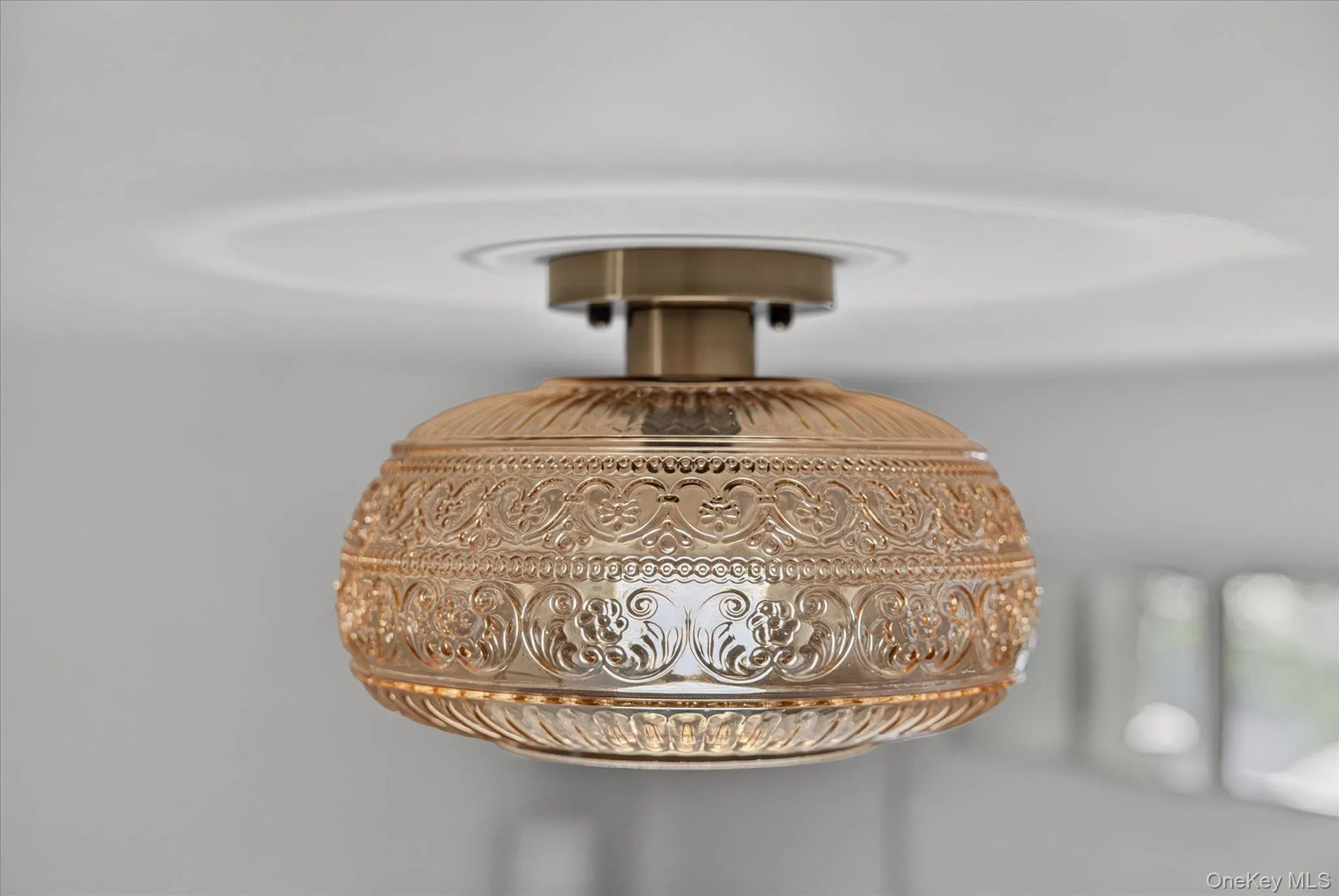 Embossed amber glass ceiling light fixture with a decorative brass base Embossed amber glass ceiling light fixture with a decorative brass base