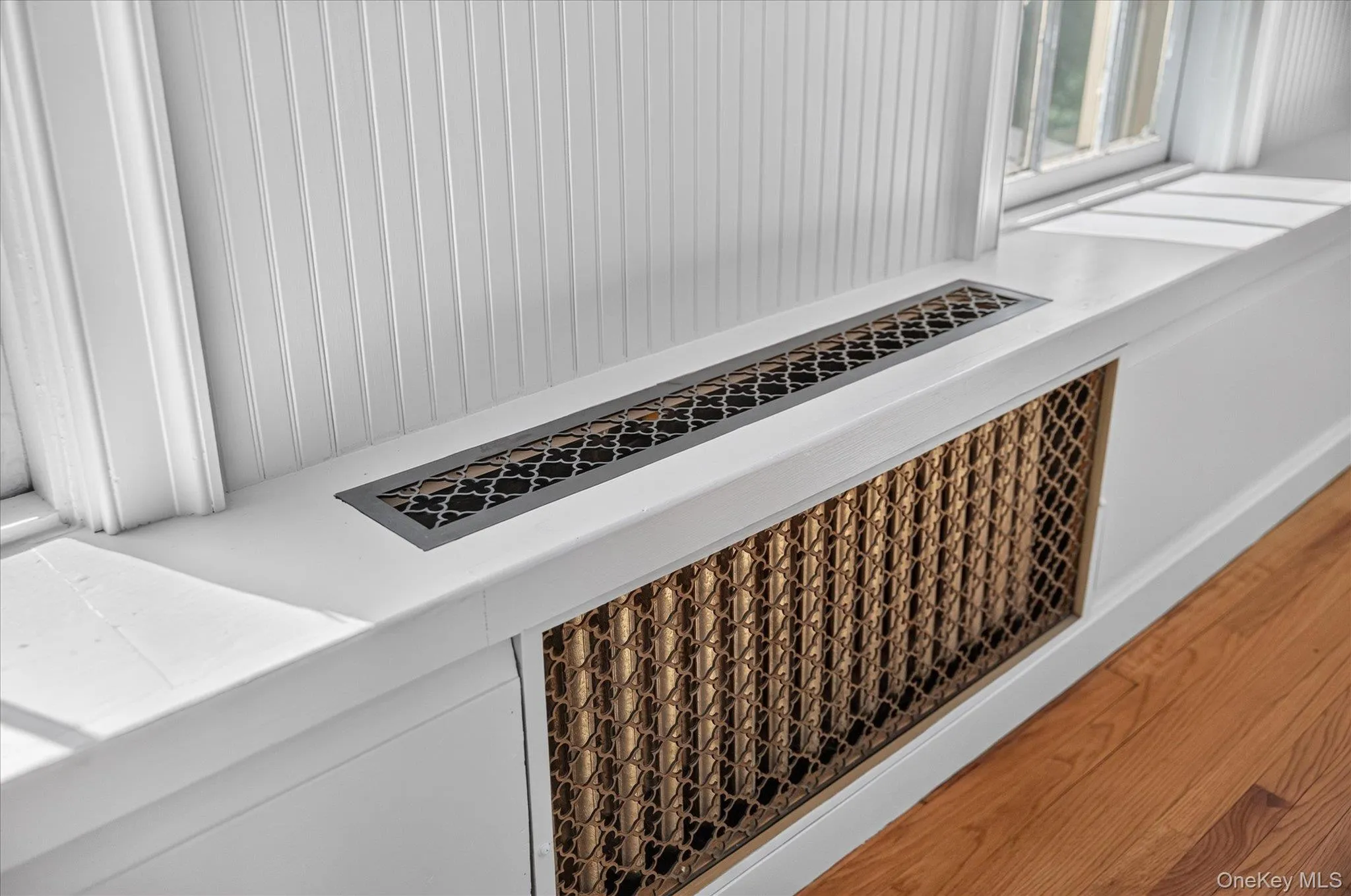 Custom radiator cover with decorative grille and coordinating floor vent Custom radiator cover with decorative grille and coordinating floor vent