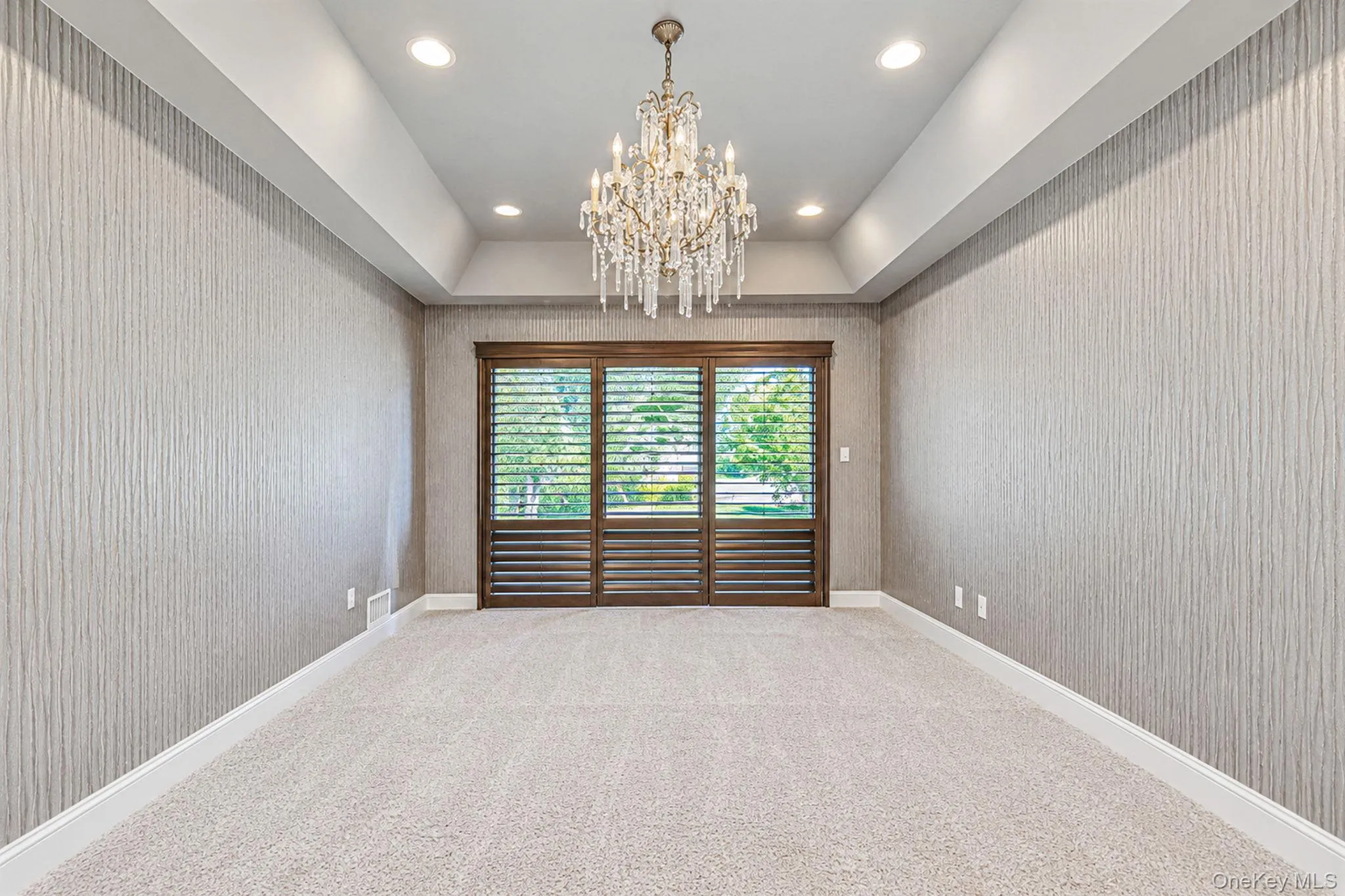 Large primary bedroom with golf course views Large primary bedroom with golf course views