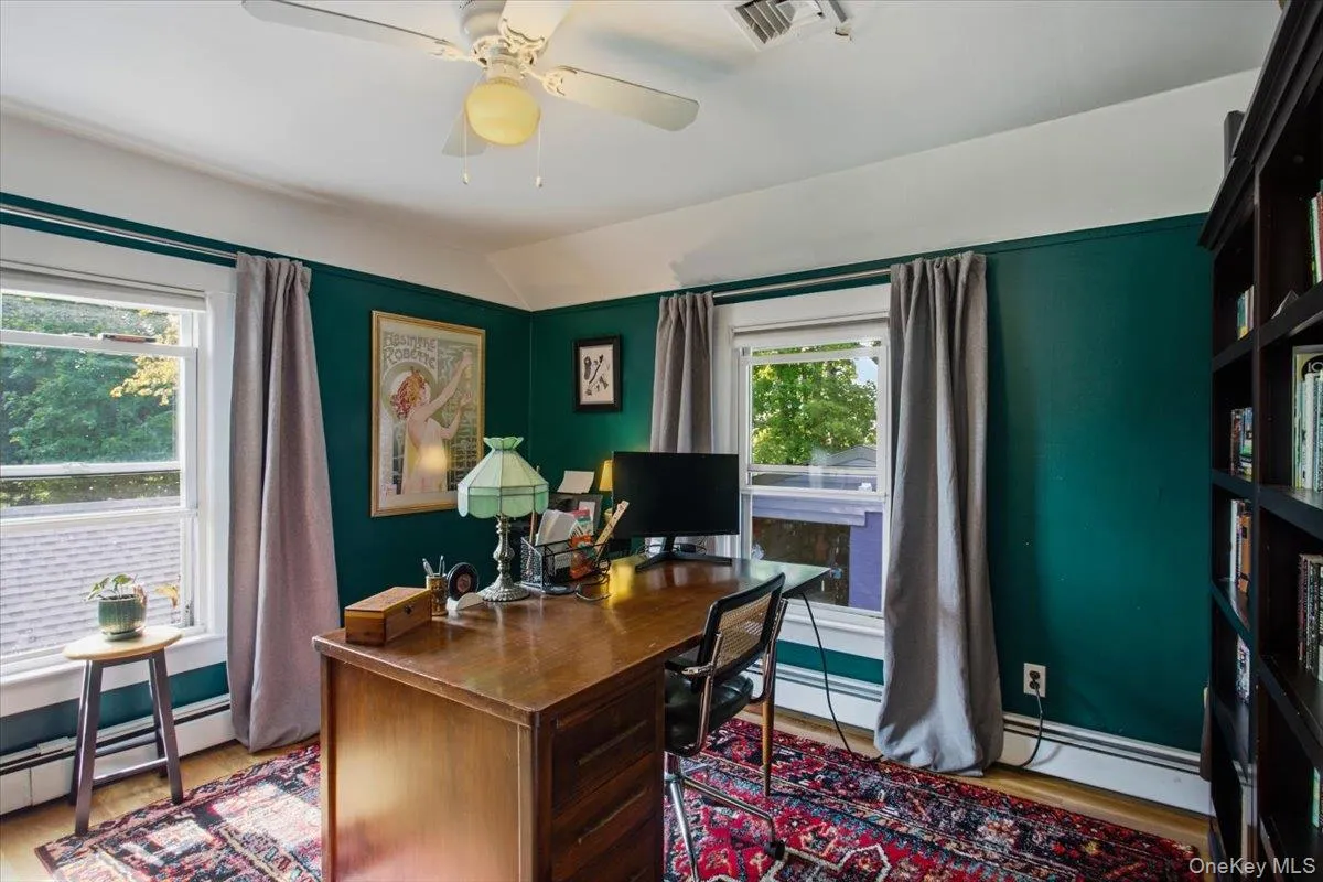 Upstairs, the third bedroom is being used as a formal office. Upstairs, the third bedroom is being used as a formal office.