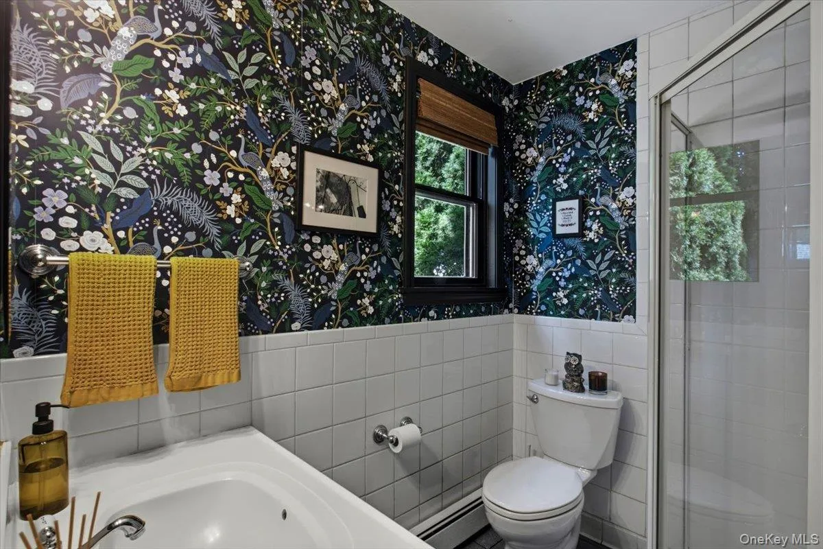The lower level bathroom includes a standing shower. The lower level bathroom includes a standing shower.