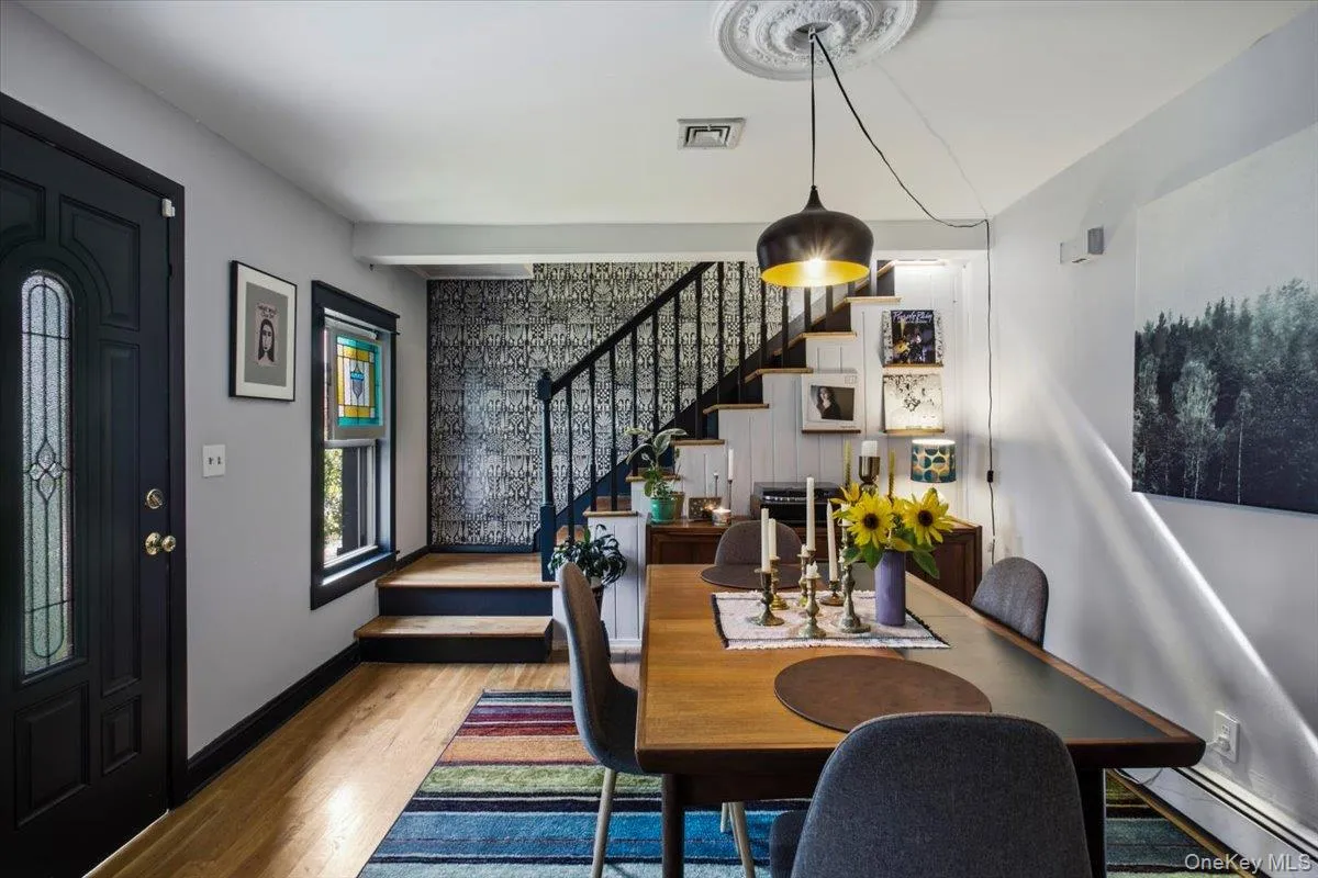 Enter through the front door into a versatile room currently styled as a dining room. Previously used as a living room, the space could just as easily become a library or sitting room for those who prefer a less formal approach to dining. Enter through the front door into a versatile room currently styled as a dining room. Previously used as a living room, the space could just as easily become a library or sitting room for those who prefer a less formal approach to dining.