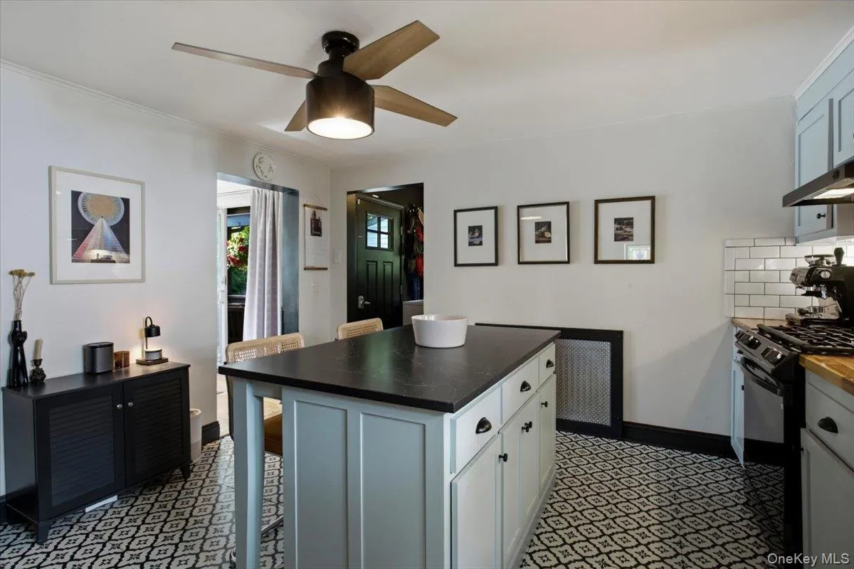 The oversized island offers lots of seating space. Behind the wall on the left is the living room and behind the wall on the right is the laundry and a full bathroom. The oversized island offers lots of seating space. Behind the wall on the left is the living room and behind the wall on the right is the laundry and a full bathroom.