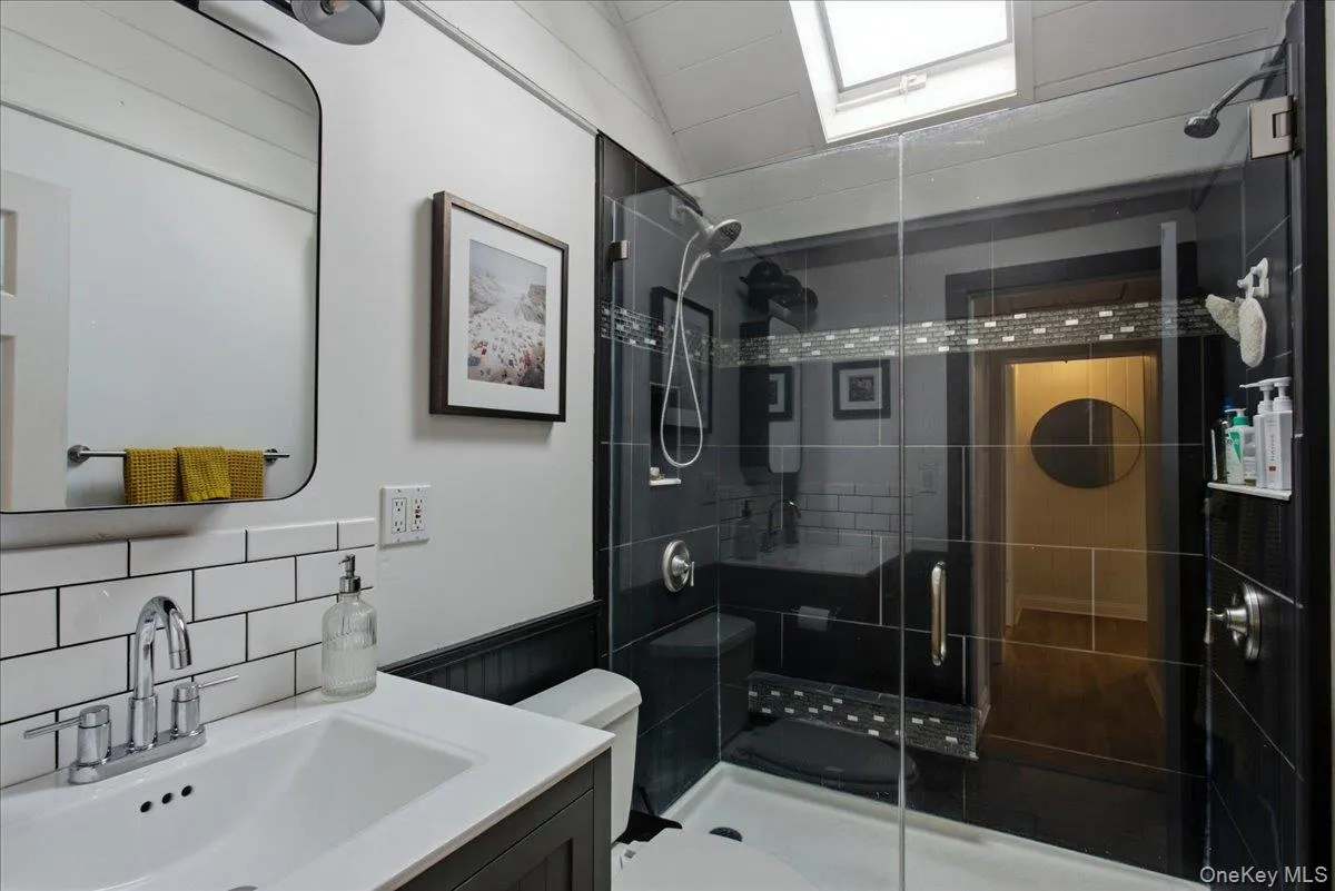 View of the full bathroom on the second floor. Lit by a skylight, the space feels airy while still being private. View of the full bathroom on the second floor. Lit by a skylight, the space feels airy while still being private.