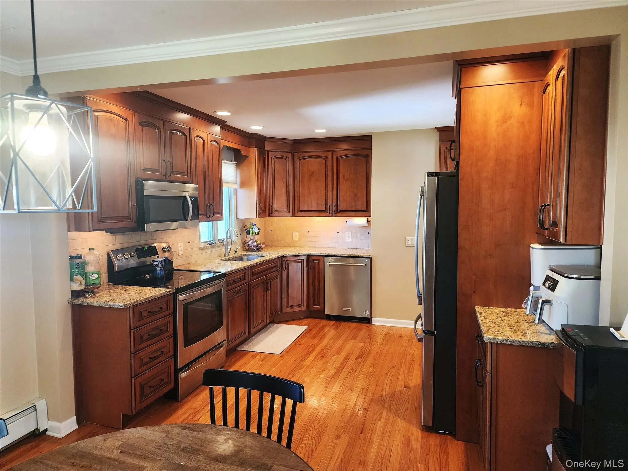 Remodeled Kitchen with hardwood floors Granite countertops and stainless steel appliances Remodeled Kitchen with hardwood floors Granite countertops and stainless steel appliances