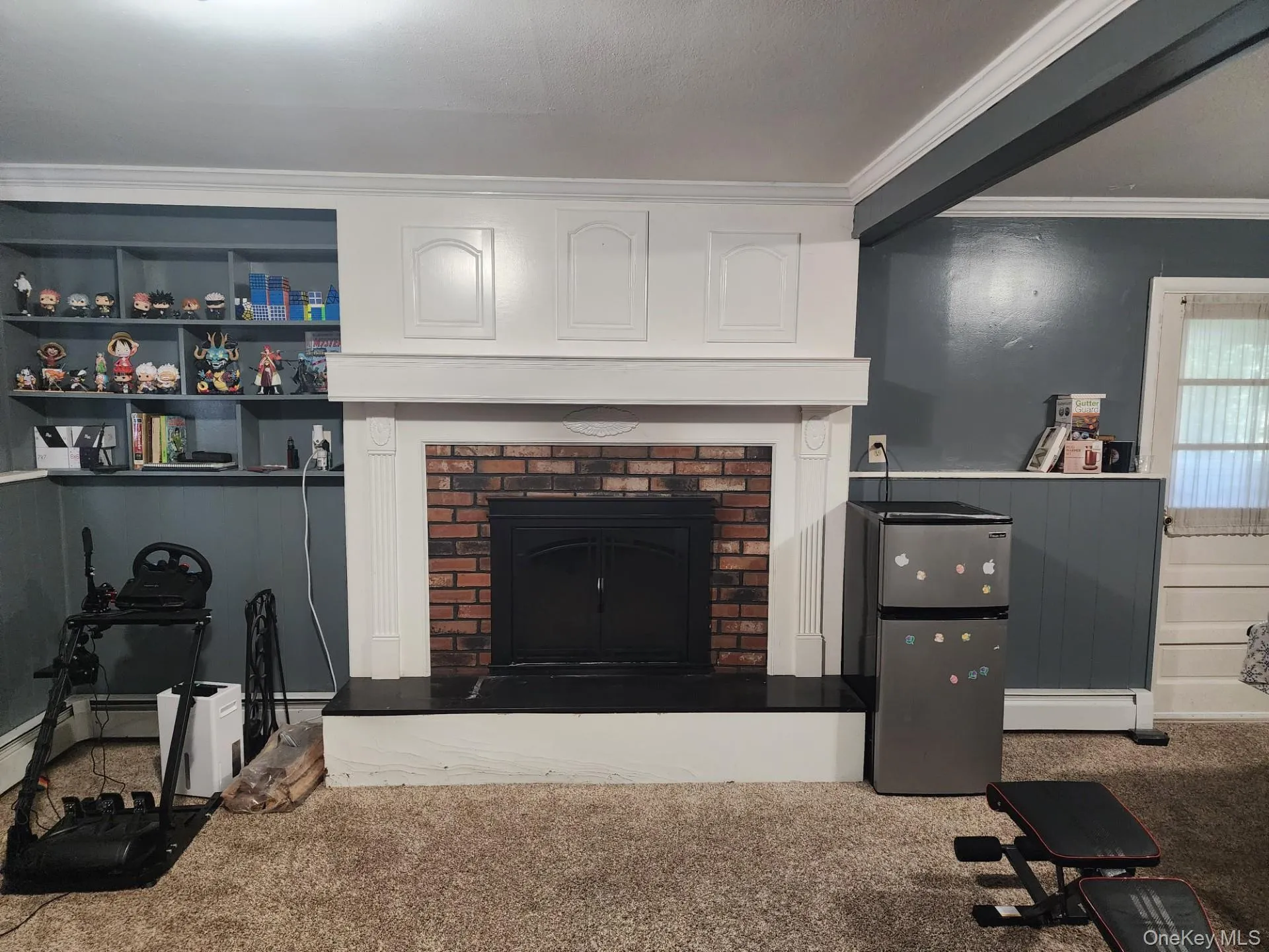 Family Room w Brick fireplace and access to storage room Family Room w Brick fireplace and access to storage room