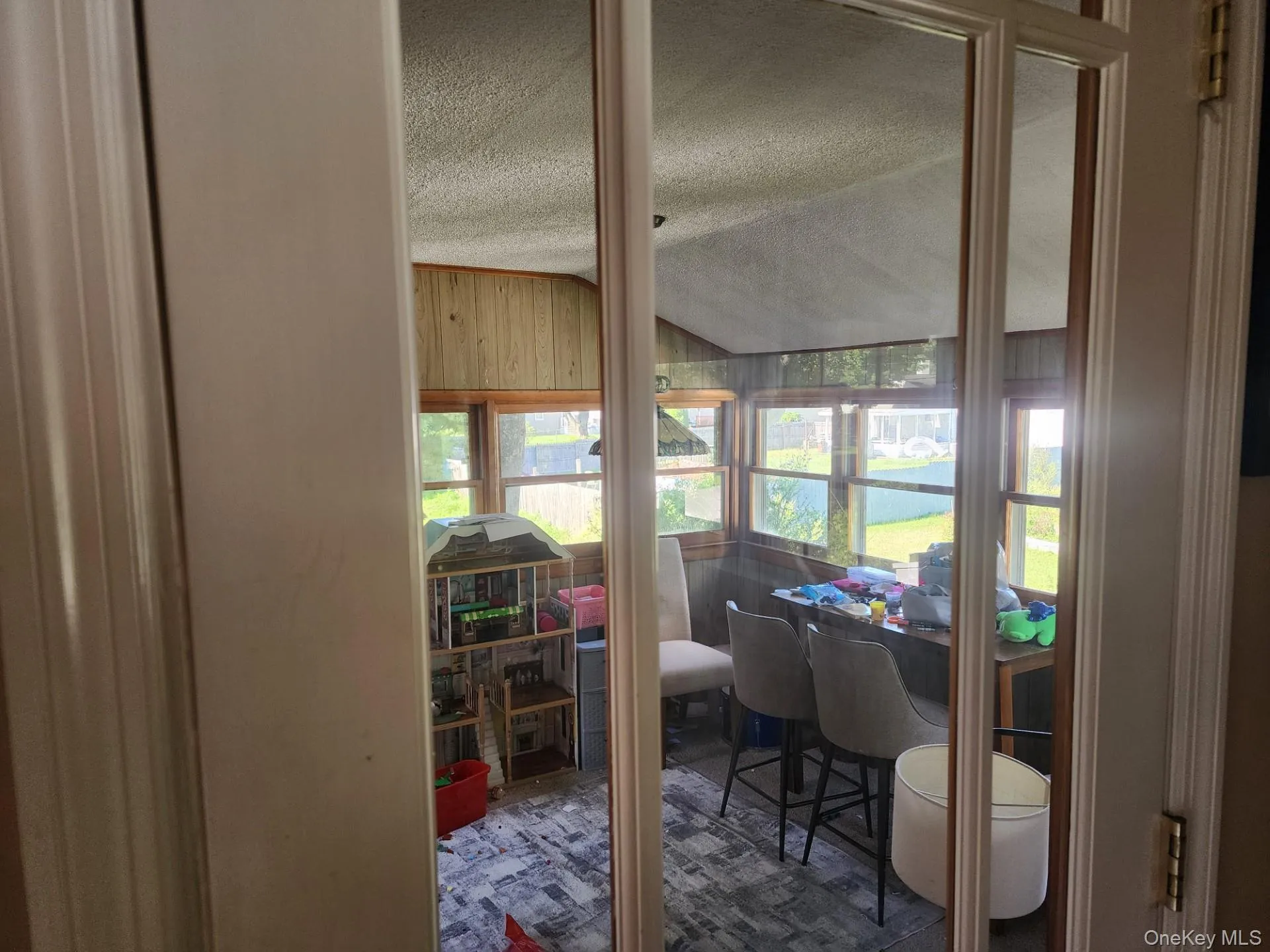 Door off of the dining Room into the addition easily used as a playroom or office area Door off of the dining Room into the addition easily used as a playroom or office area