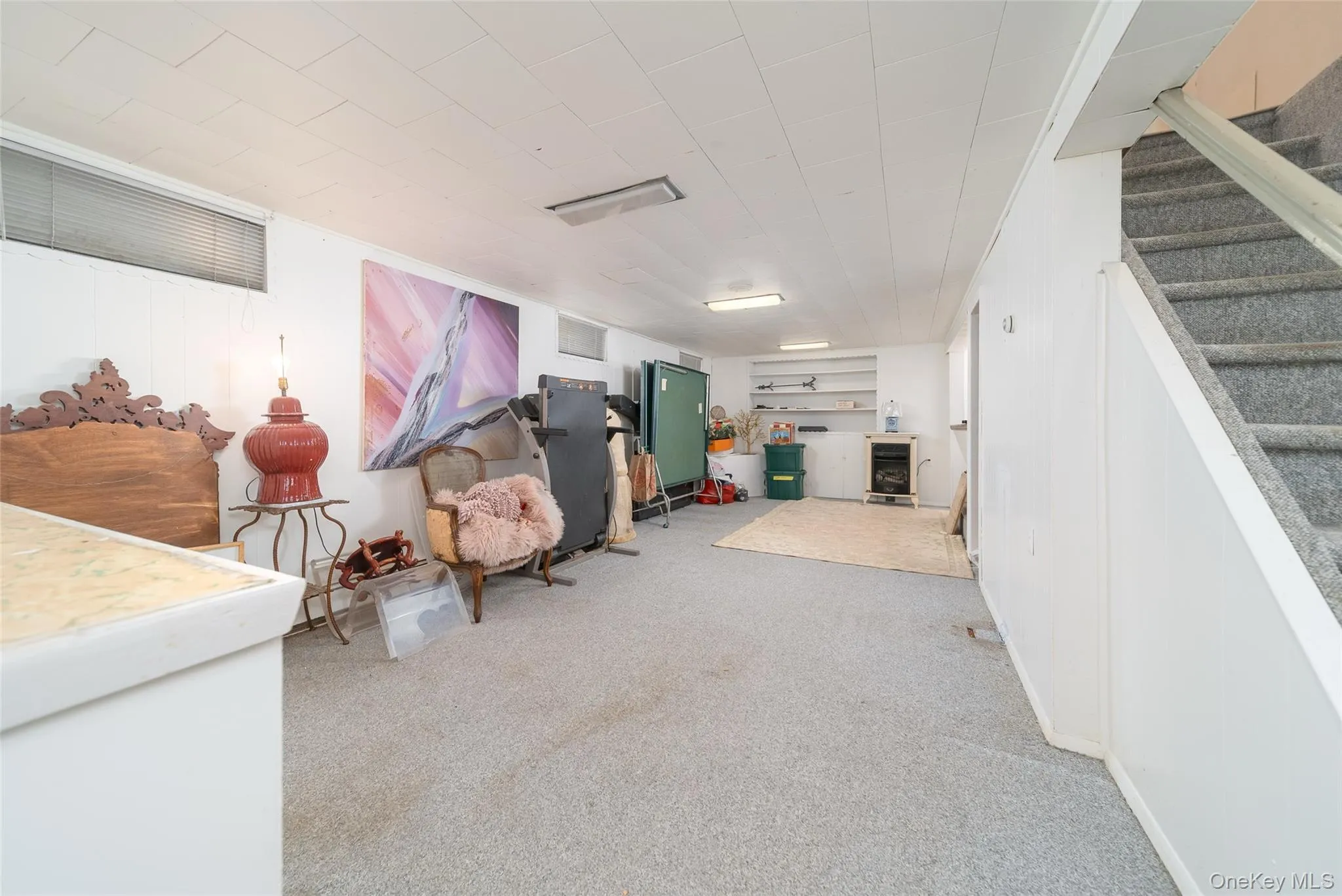 Finished below grade area with carpet flooring and stairs Finished below grade area with carpet flooring and stairs
