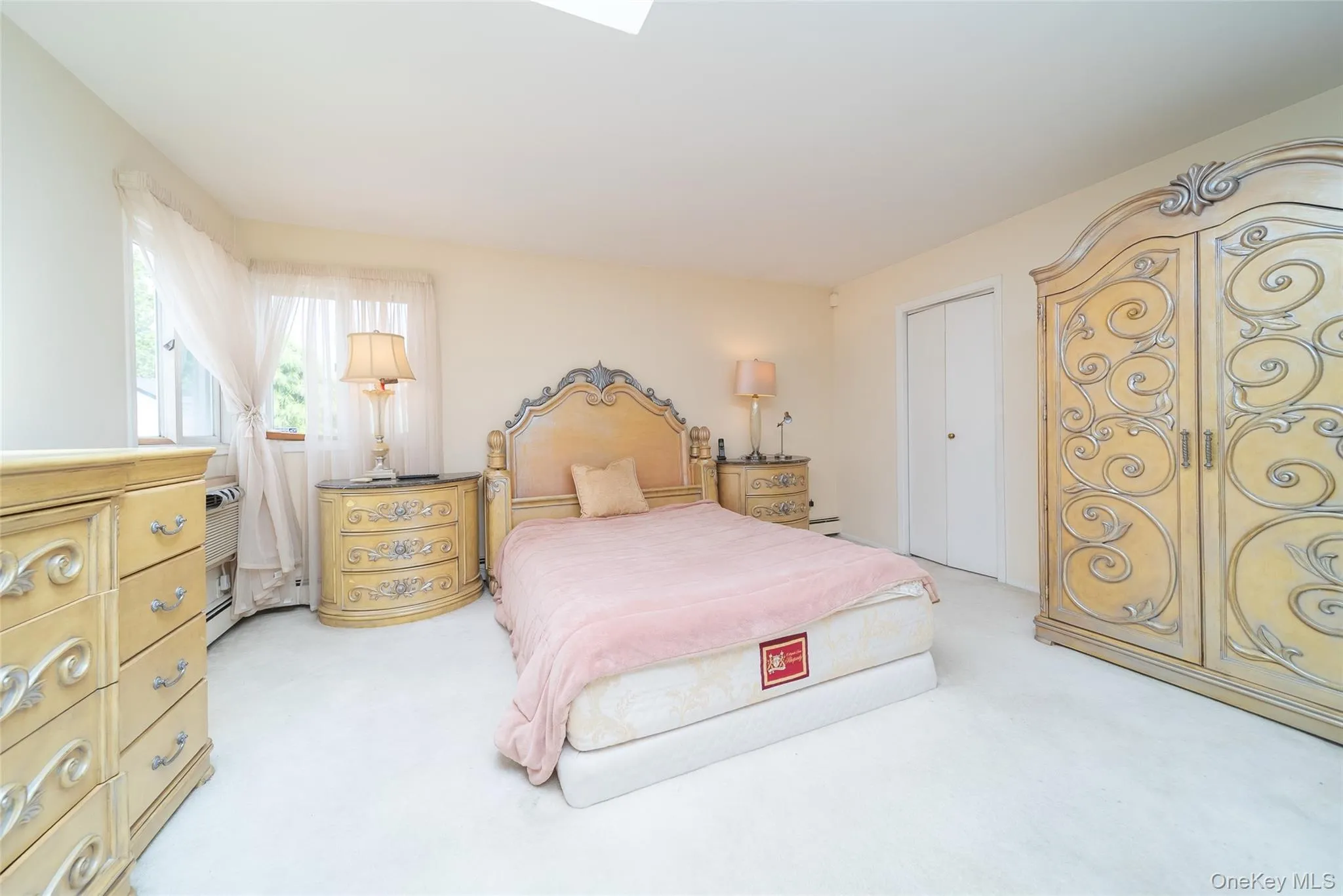 Bedroom featuring light colored carpet and a closet Bedroom featuring light colored carpet and a closet