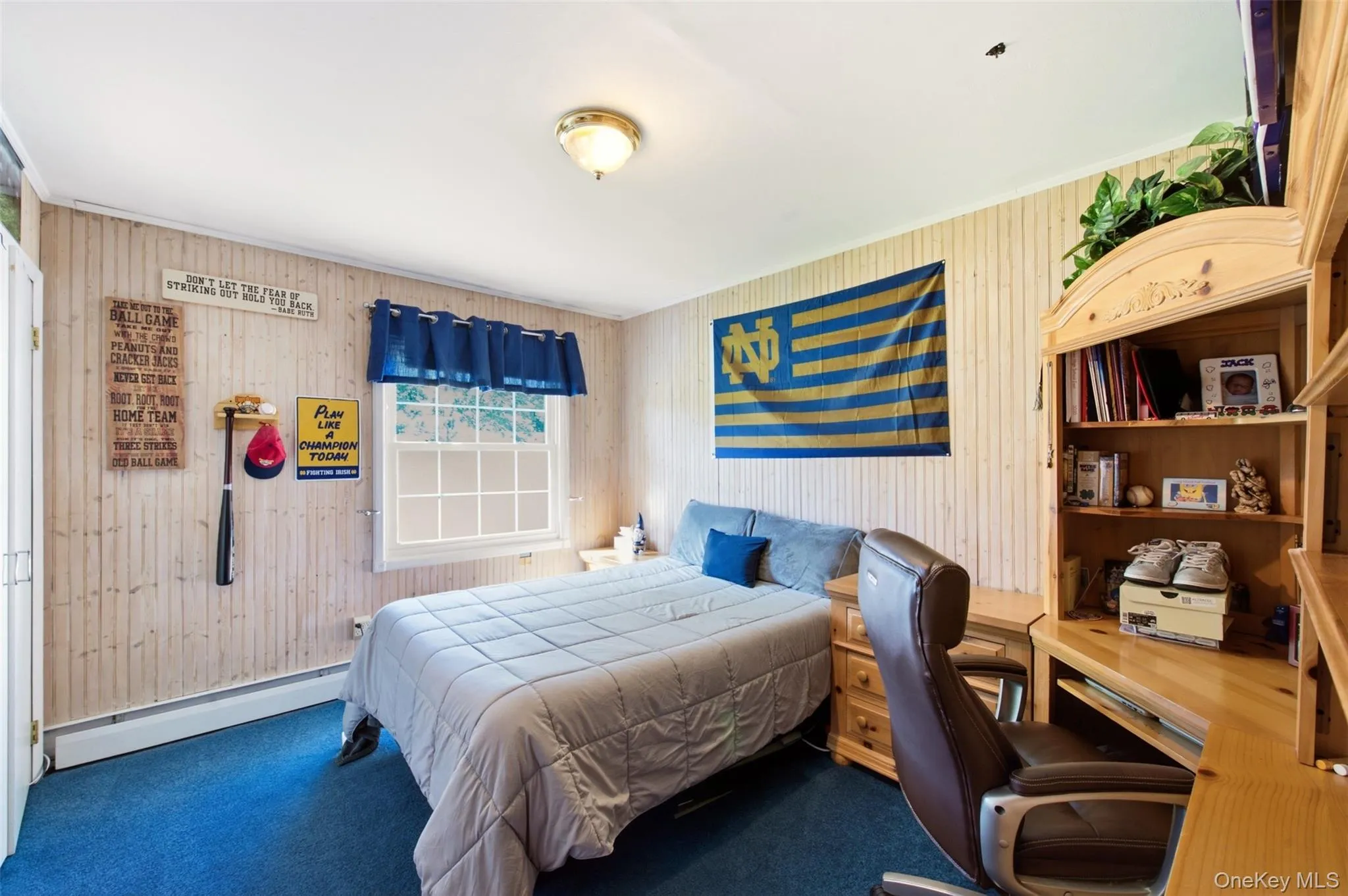 Vertical plank wall paneling, built-in shelving, and a double-paned window Vertical plank wall paneling, built-in shelving, and a double-paned window