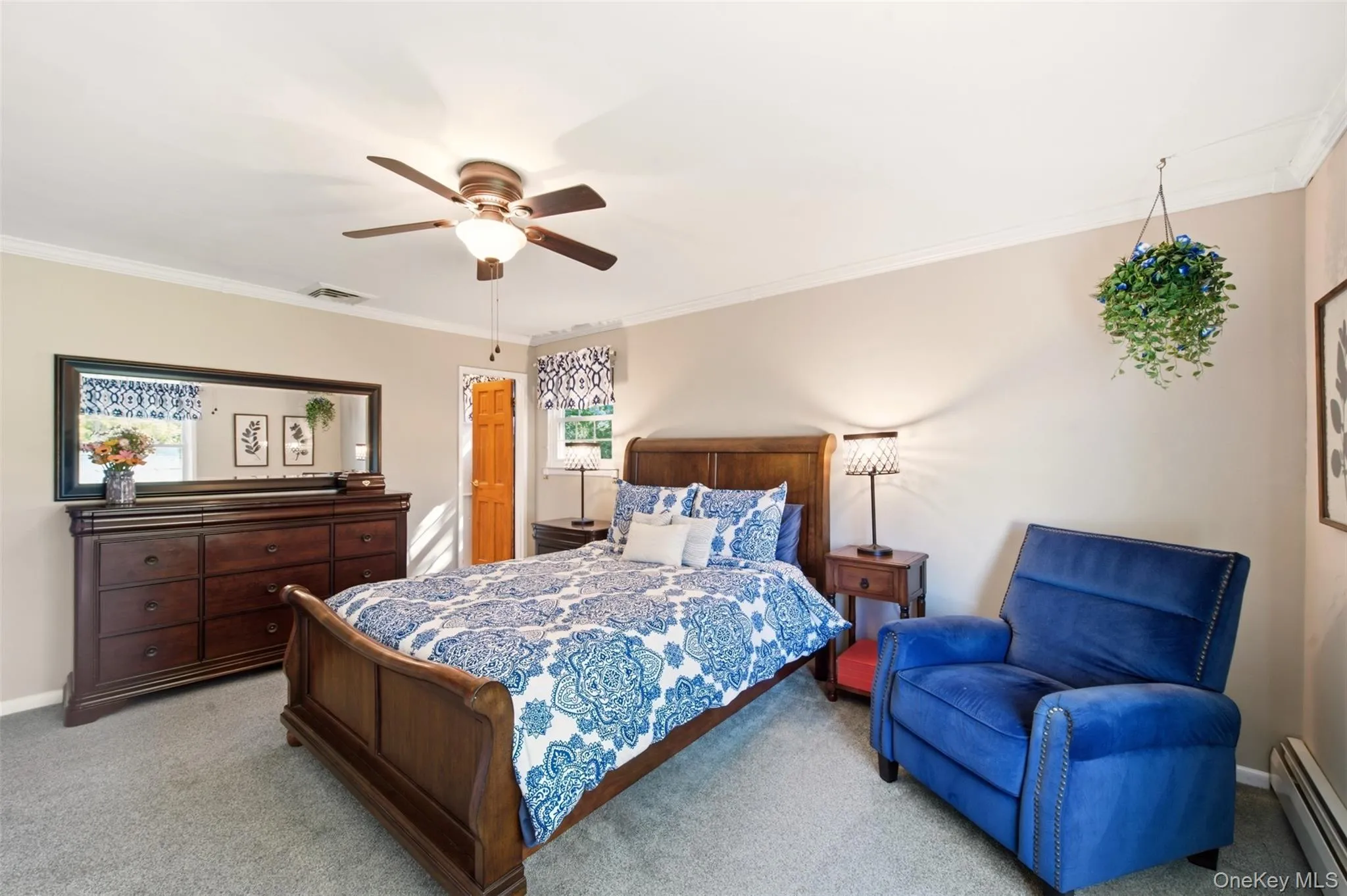Carpeted flooring, crown molding, and a ceiling fan with integrated lighting Carpeted flooring, crown molding, and a ceiling fan with integrated lighting
