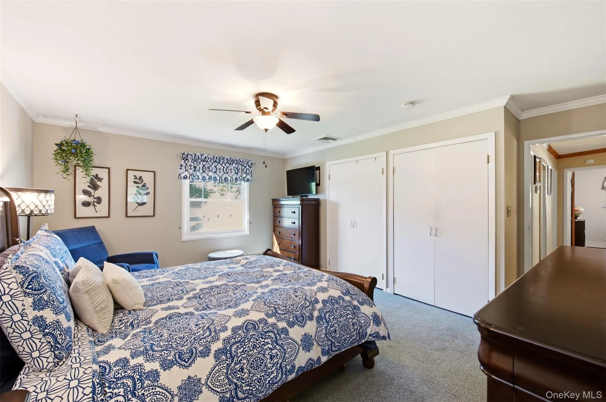 Recessed lighting, crown molding, double bi-fold closet doors, and a ceiling fan with integrated lighting Recessed lighting, crown molding, double bi-fold closet doors, and a ceiling fan with integrated lighting