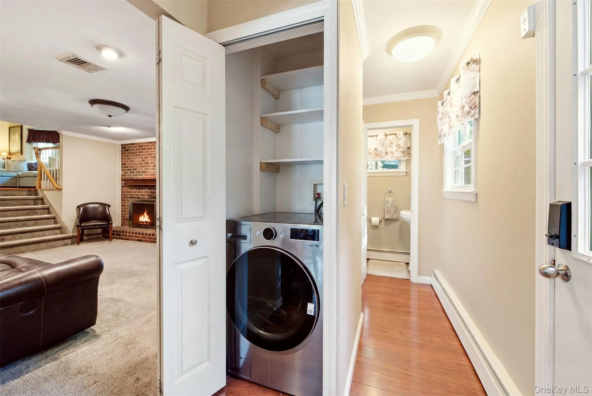 Washer and dryer in a dedicated closet with shelving Washer and dryer in a dedicated closet with shelving