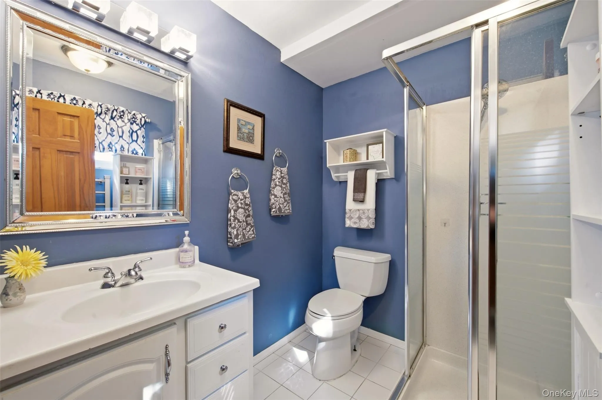 White vanity with integrated sink, chrome faucet, and framed mirror White vanity with integrated sink, chrome faucet, and framed mirror