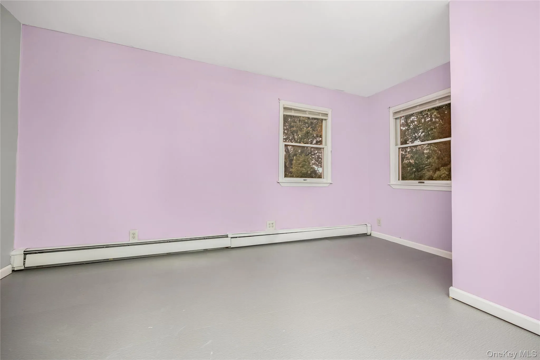 Empty room with baseboards and a baseboard radiator Empty room with baseboards and a baseboard radiator