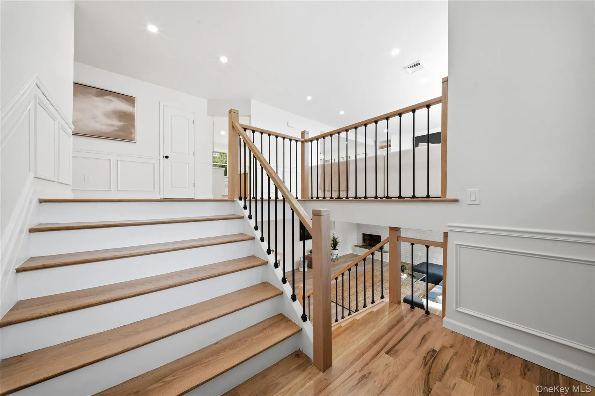 Hardwood flooring, custom balusters, recessed lighting, wainscoting, and crisp white trim Hardwood flooring, custom balusters, recessed lighting, wainscoting, and crisp white trim