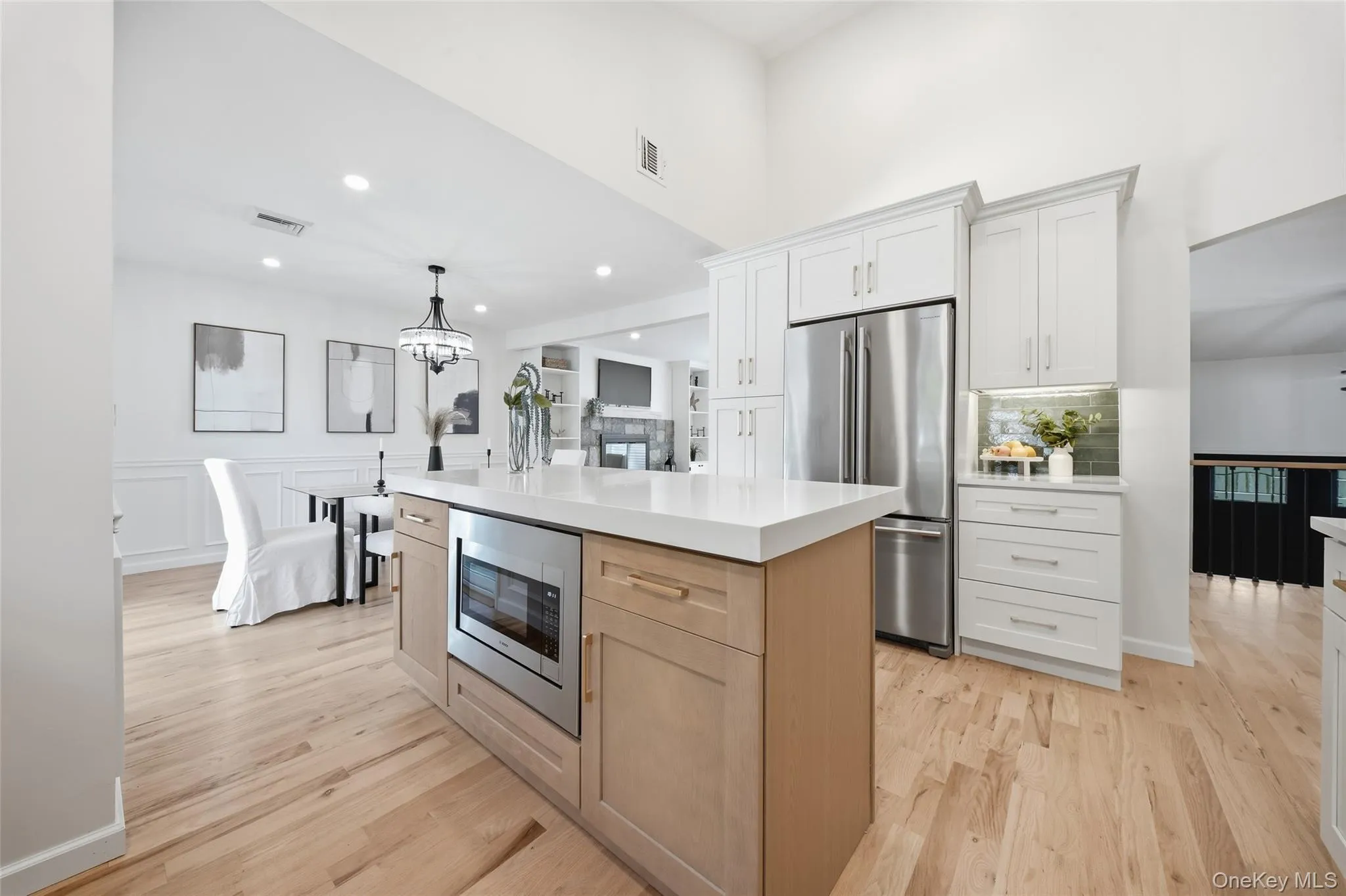 Integrated kitchen and dining area featuring light wood-finish flooring Integrated kitchen and dining area featuring light wood-finish flooring