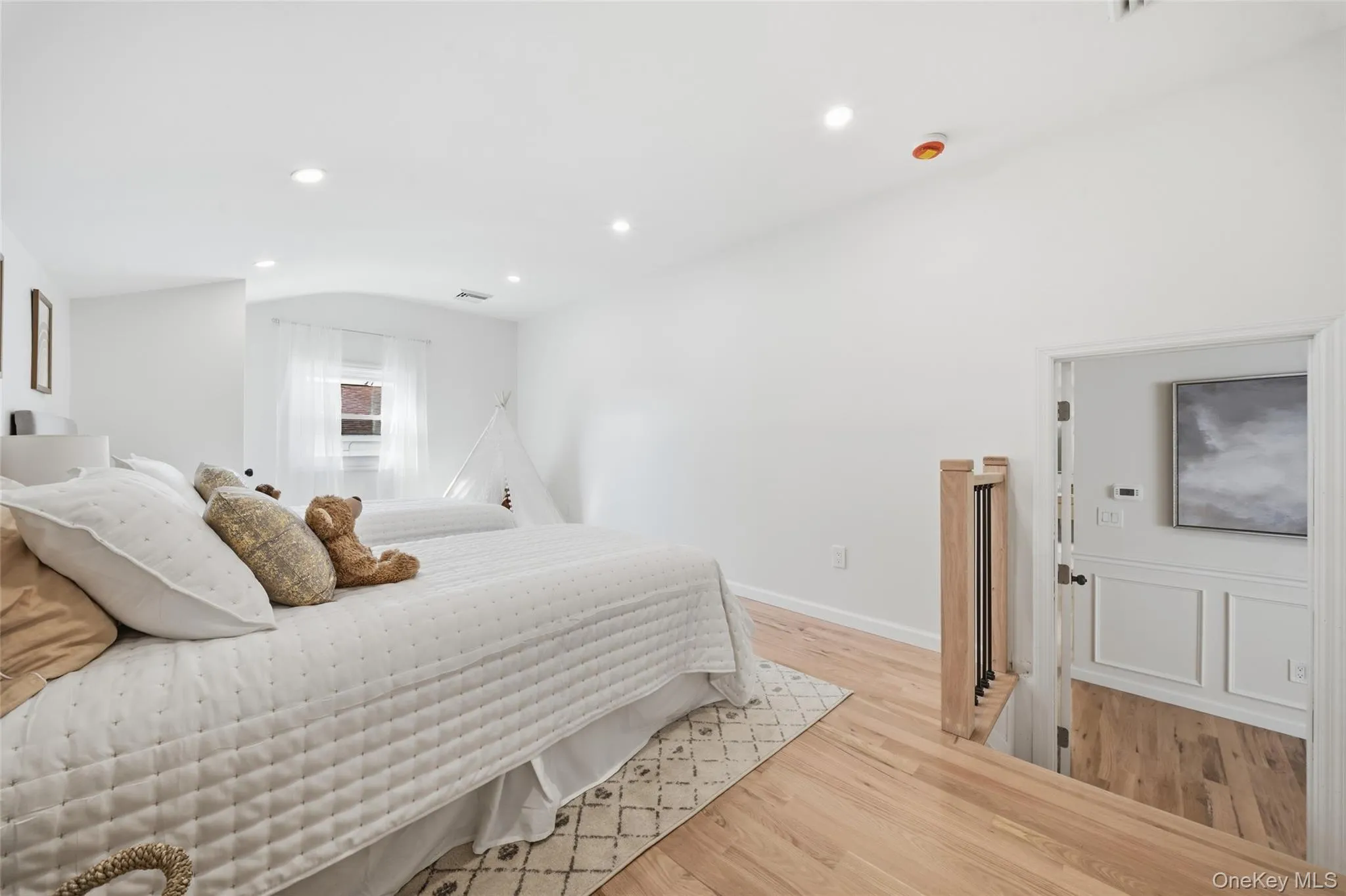 Bedroom,Recessed lighting illuminates the white walls and wood-finish flooring Bedroom,Recessed lighting illuminates the white walls and wood-finish flooring
