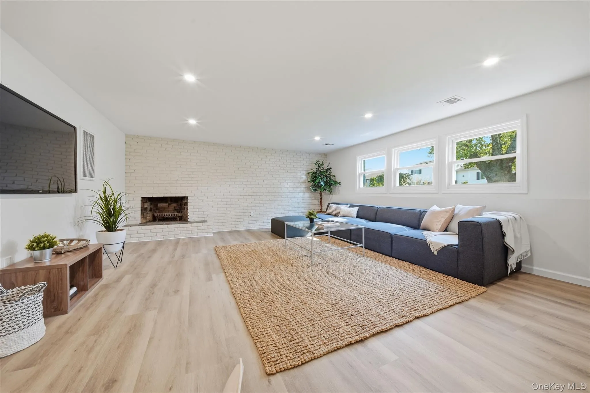 Lower level done with white brick wood burning fireplace Lower level done with white brick wood burning fireplace