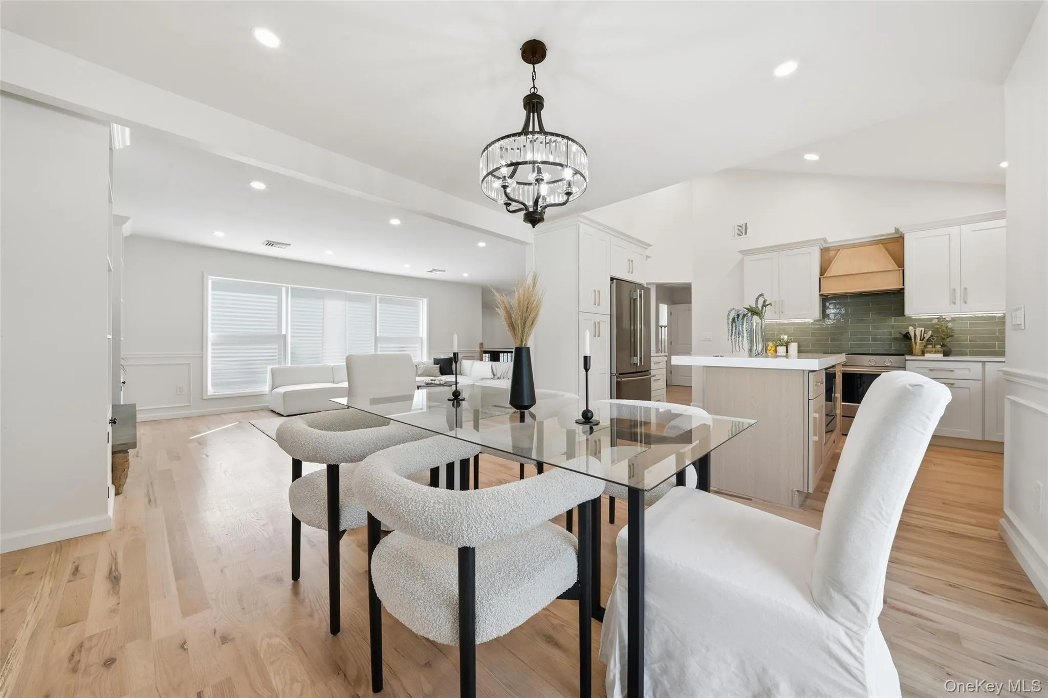 Wood-finish flooring throughout, vaulted ceilings, recessed lighting, and a modern chandelier Wood-finish flooring throughout, vaulted ceilings, recessed lighting, and a modern chandelier
