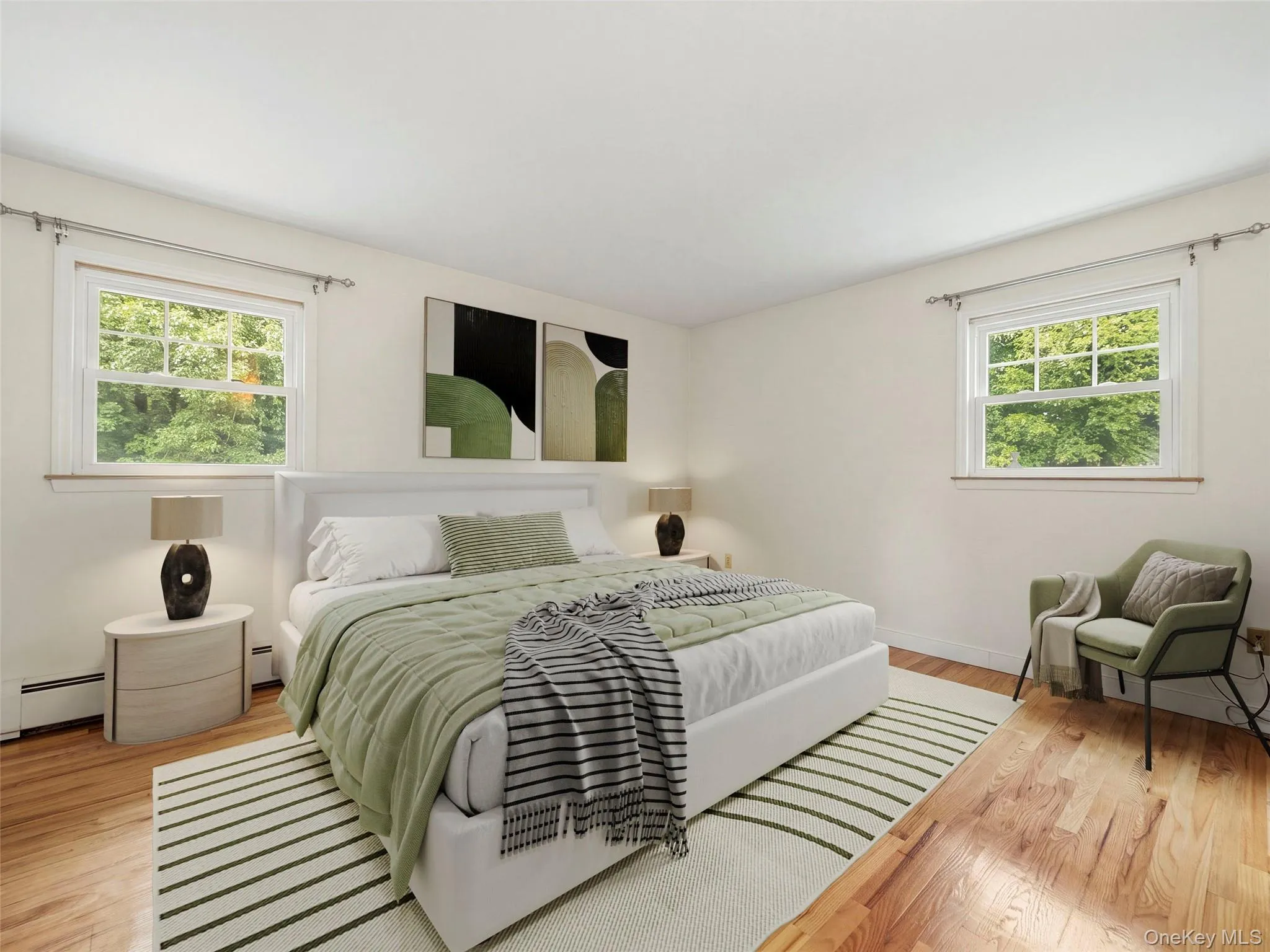 Hardwood flooring throughout, bright white walls, and two large windows with natural light Hardwood flooring throughout, bright white walls, and two large windows with natural light