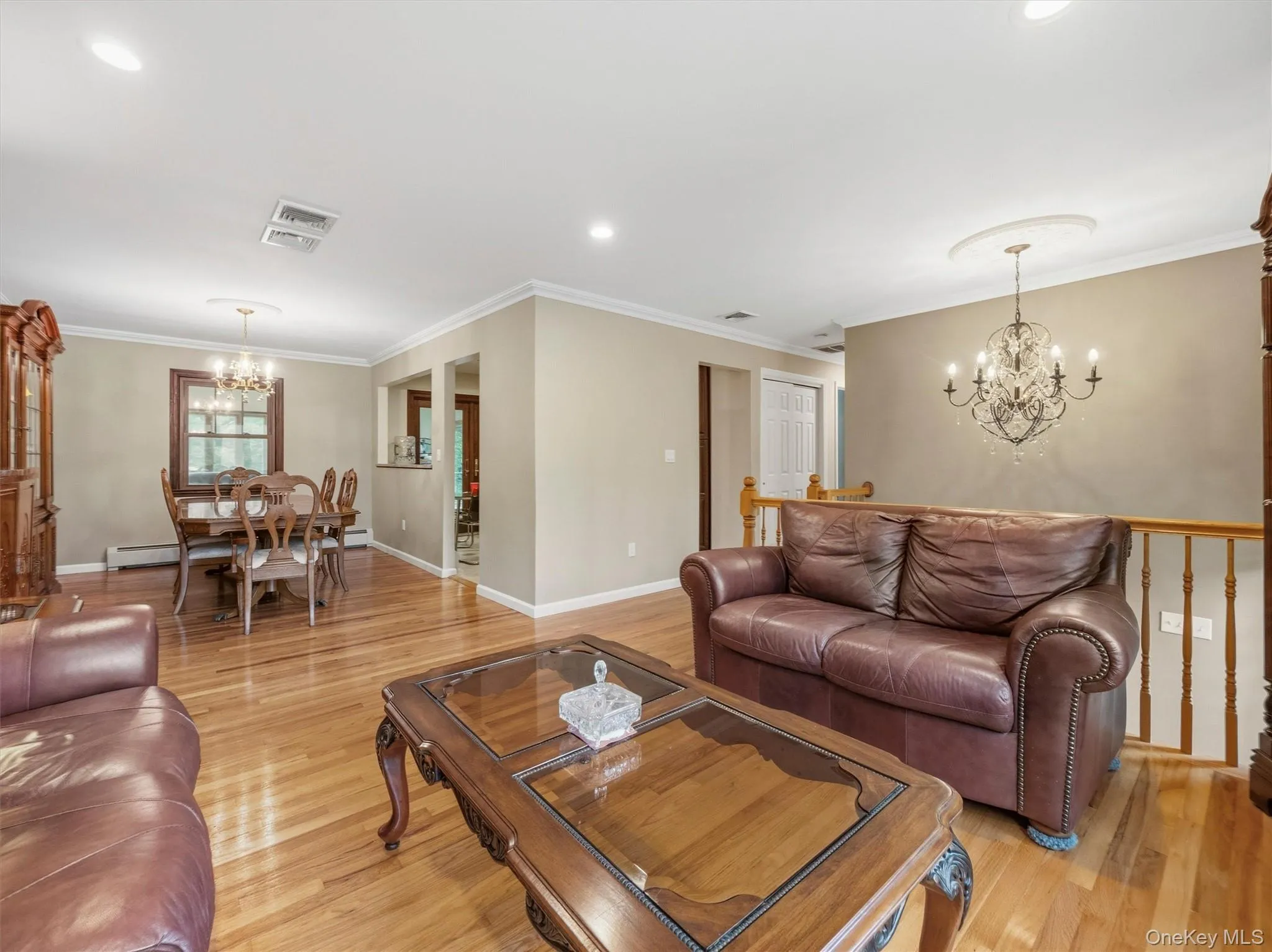 Hardwood flooring throughout, recessed lighting, crown molding, and two chandeliers Hardwood flooring throughout, recessed lighting, crown molding, and two chandeliers