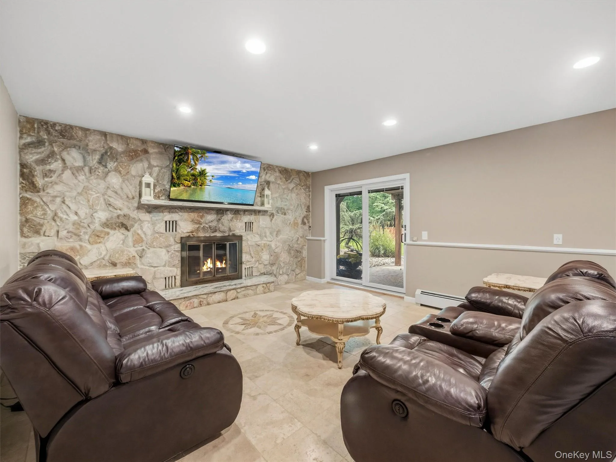 Stone accent wall with a built-in fireplace, recessed lighting, and tile flooring Stone accent wall with a built-in fireplace, recessed lighting, and tile flooring