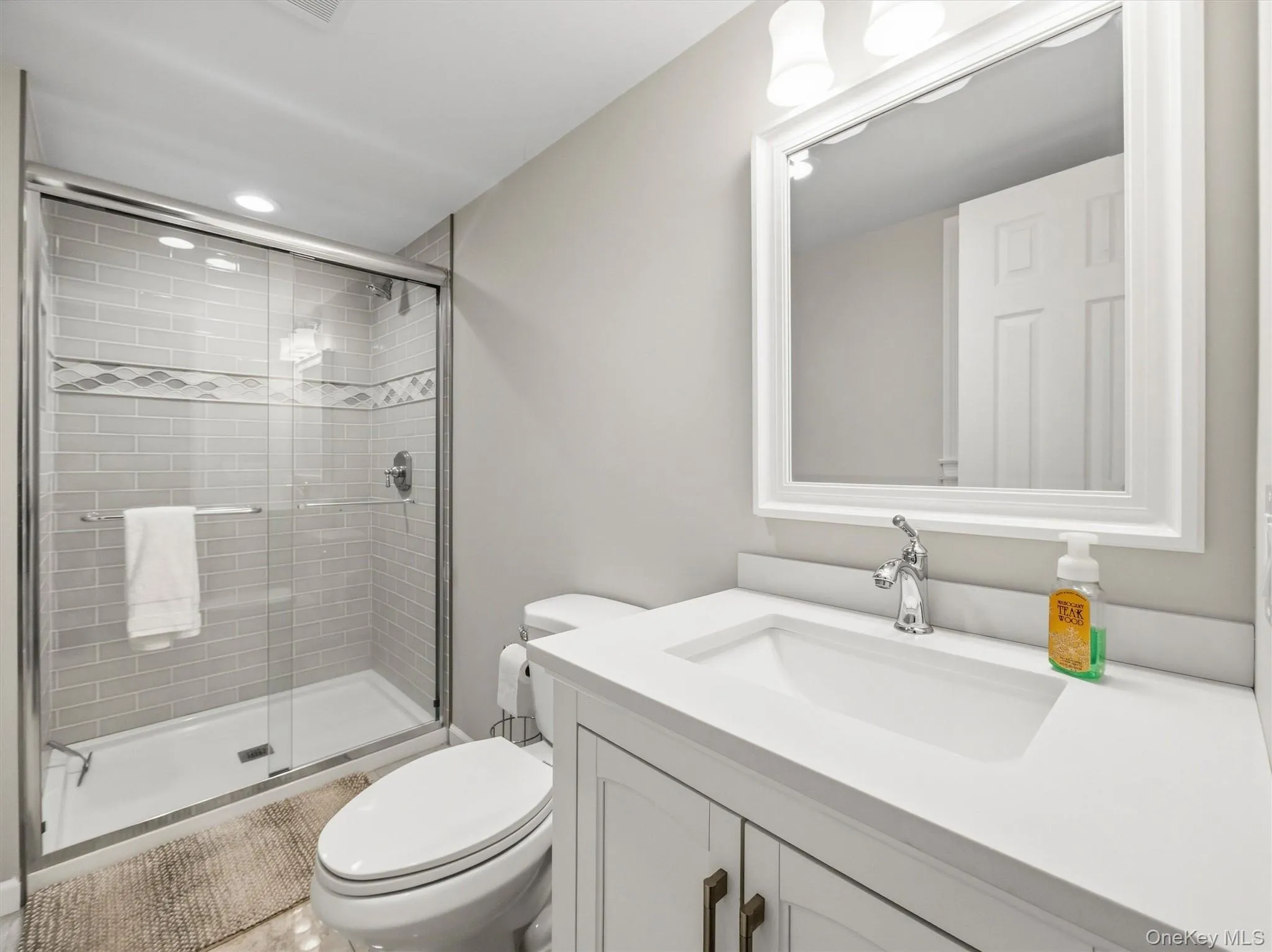 Glass-enclosed shower with subway tile surround and integrated niche Glass-enclosed shower with subway tile surround and integrated niche