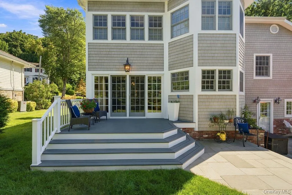 Sliders from kitchen lead out to deck overlooking lush grounds Sliders from kitchen lead out to deck overlooking lush grounds