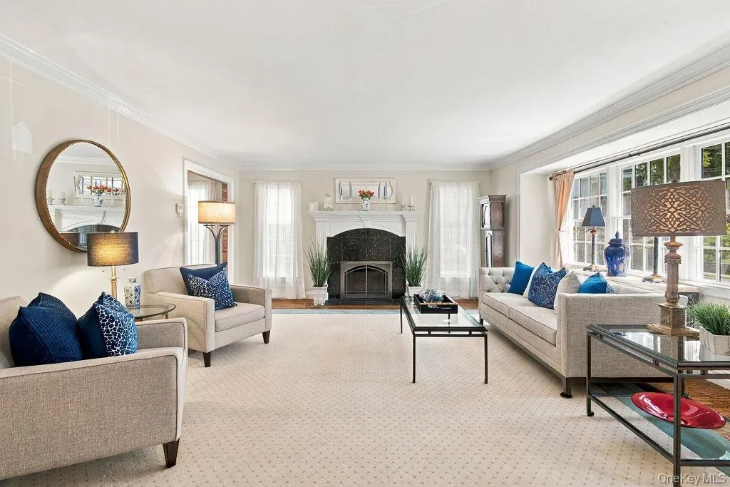 Architecturally detailed mantel above gas fireplace and classic floor to ceiling windows Architecturally detailed mantel above gas fireplace and classic floor to ceiling windows