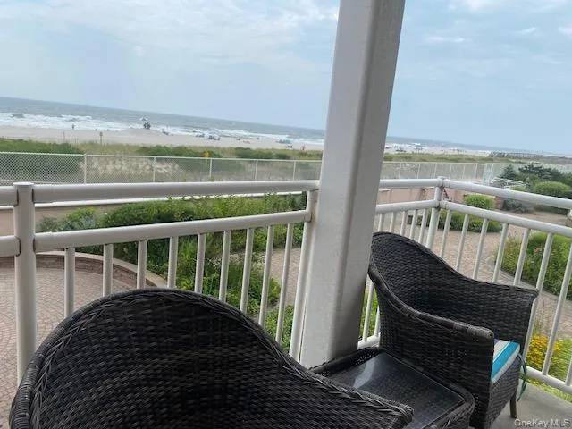 Balcony featuring a water view and a view of the beach Balcony featuring a water view and a view of the beach