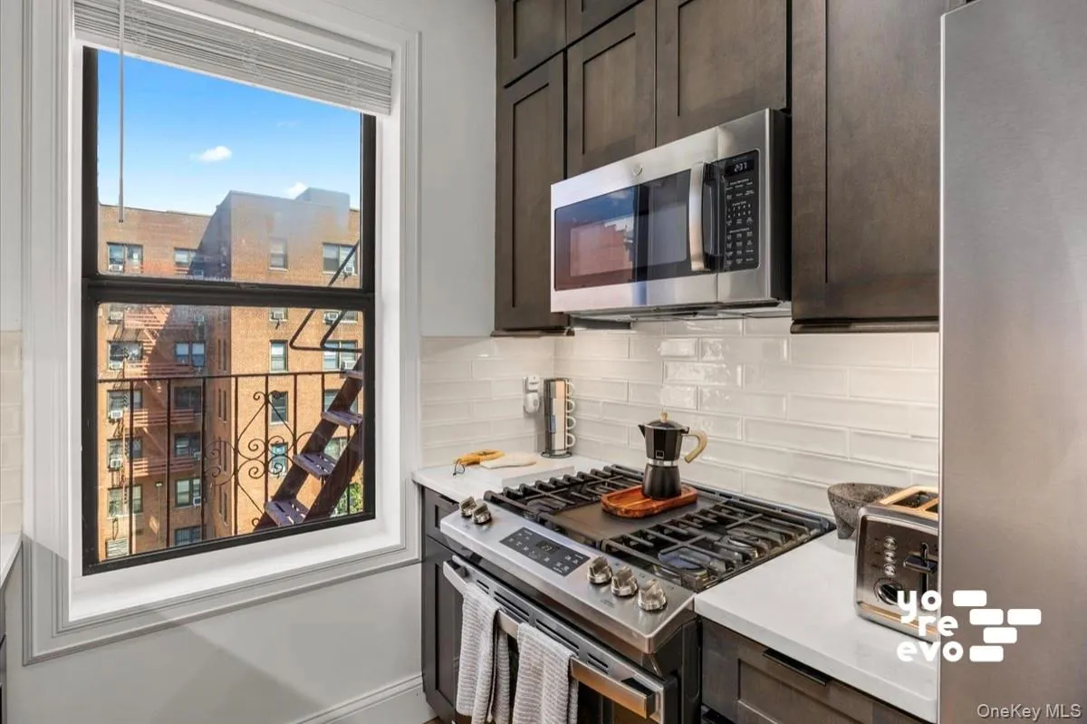 Stainless steel appliances, solid surface countertops, custom cabinetry, tiled backsplash, and under-cabinet lighting Stainless steel appliances, solid surface countertops, custom cabinetry, tiled backsplash, and under-cabinet lighting