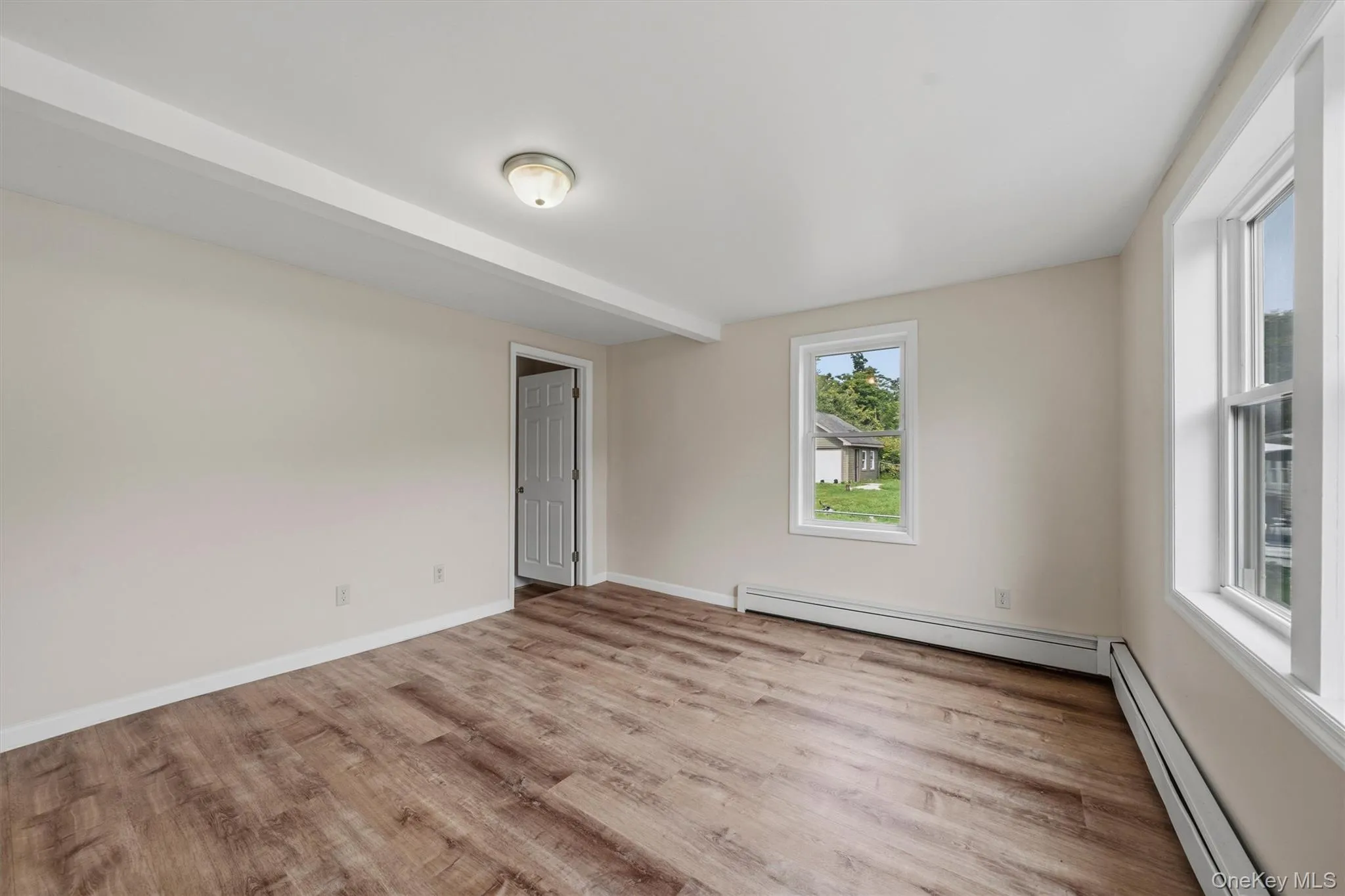 Wood-finish flooring, white trim, and neutral wall paint Wood-finish flooring, white trim, and neutral wall paint