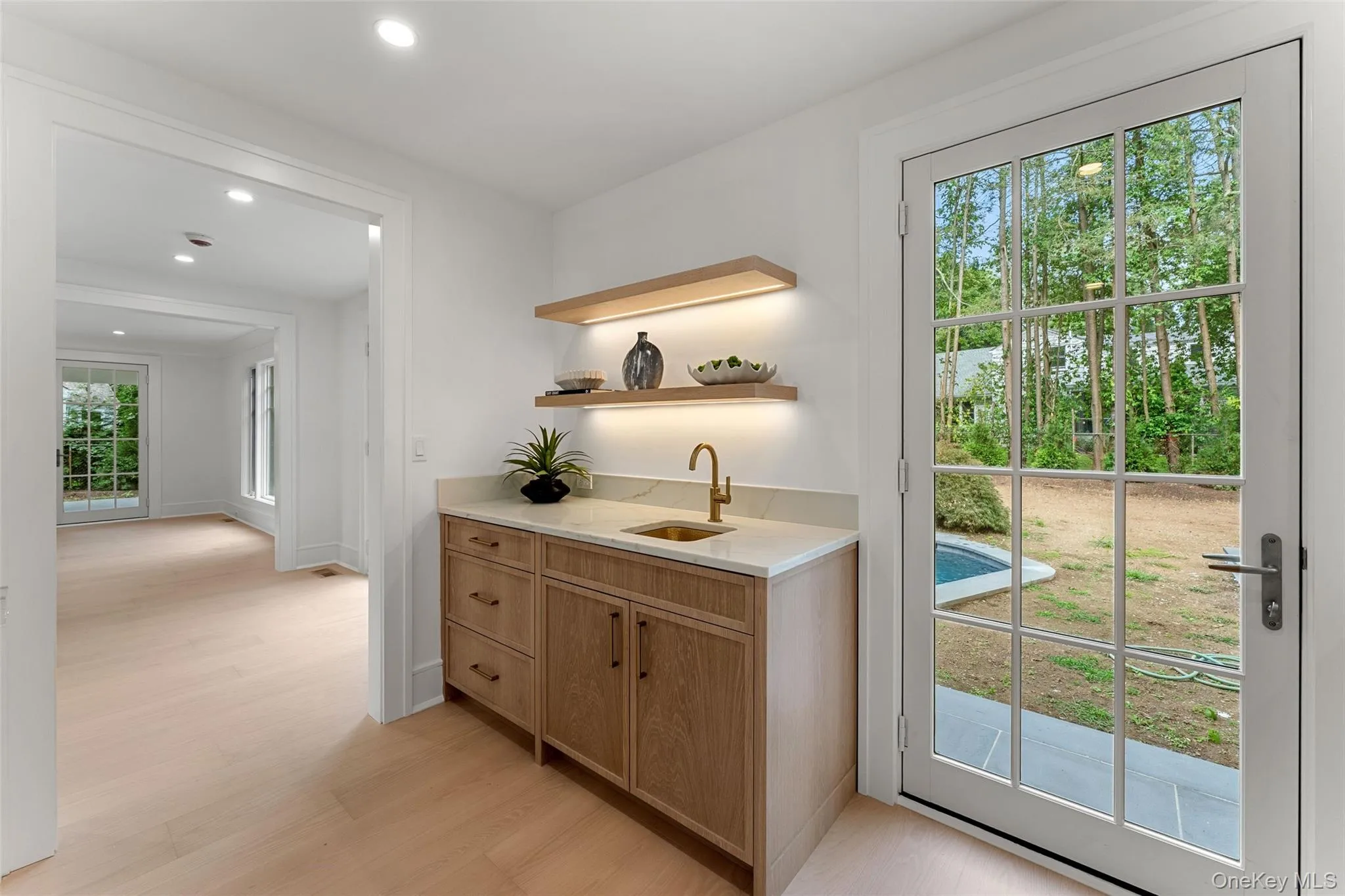 Butler's pantry with custom cabinetry and french doors to patio Butler's pantry with custom cabinetry and french doors to patio