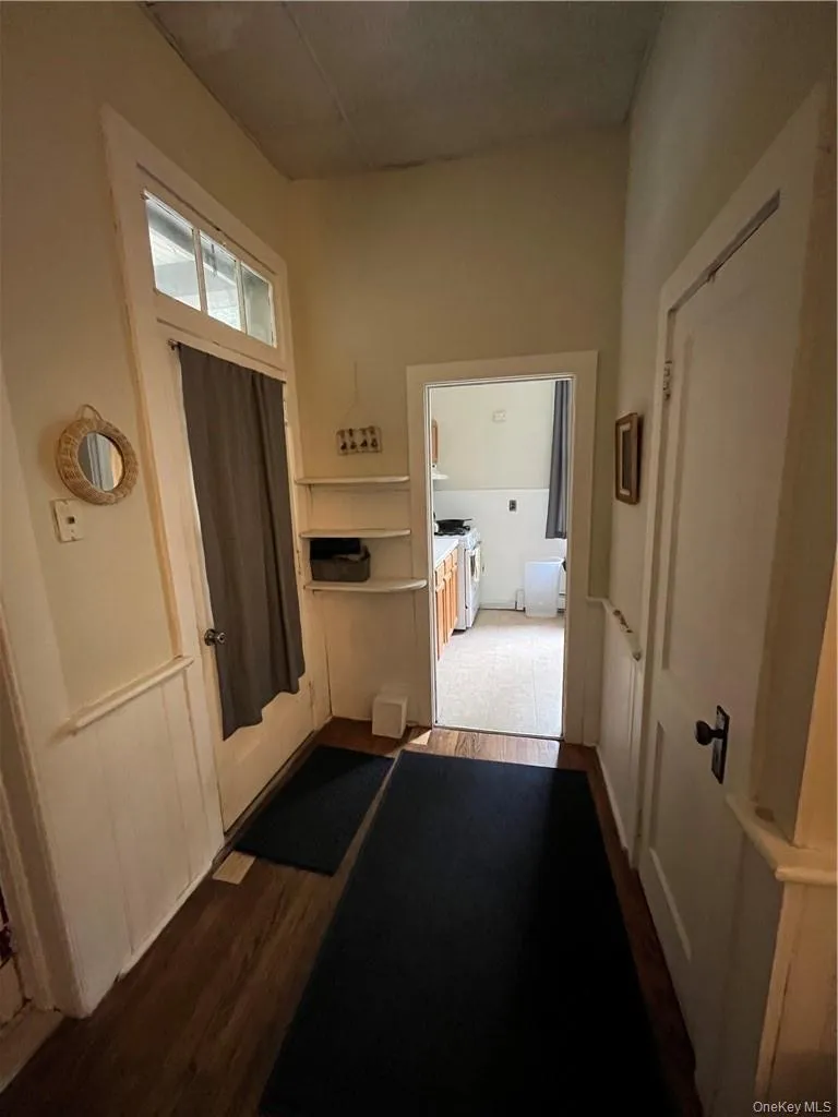 Corridor featuring hardwood floors Corridor featuring hardwood floors