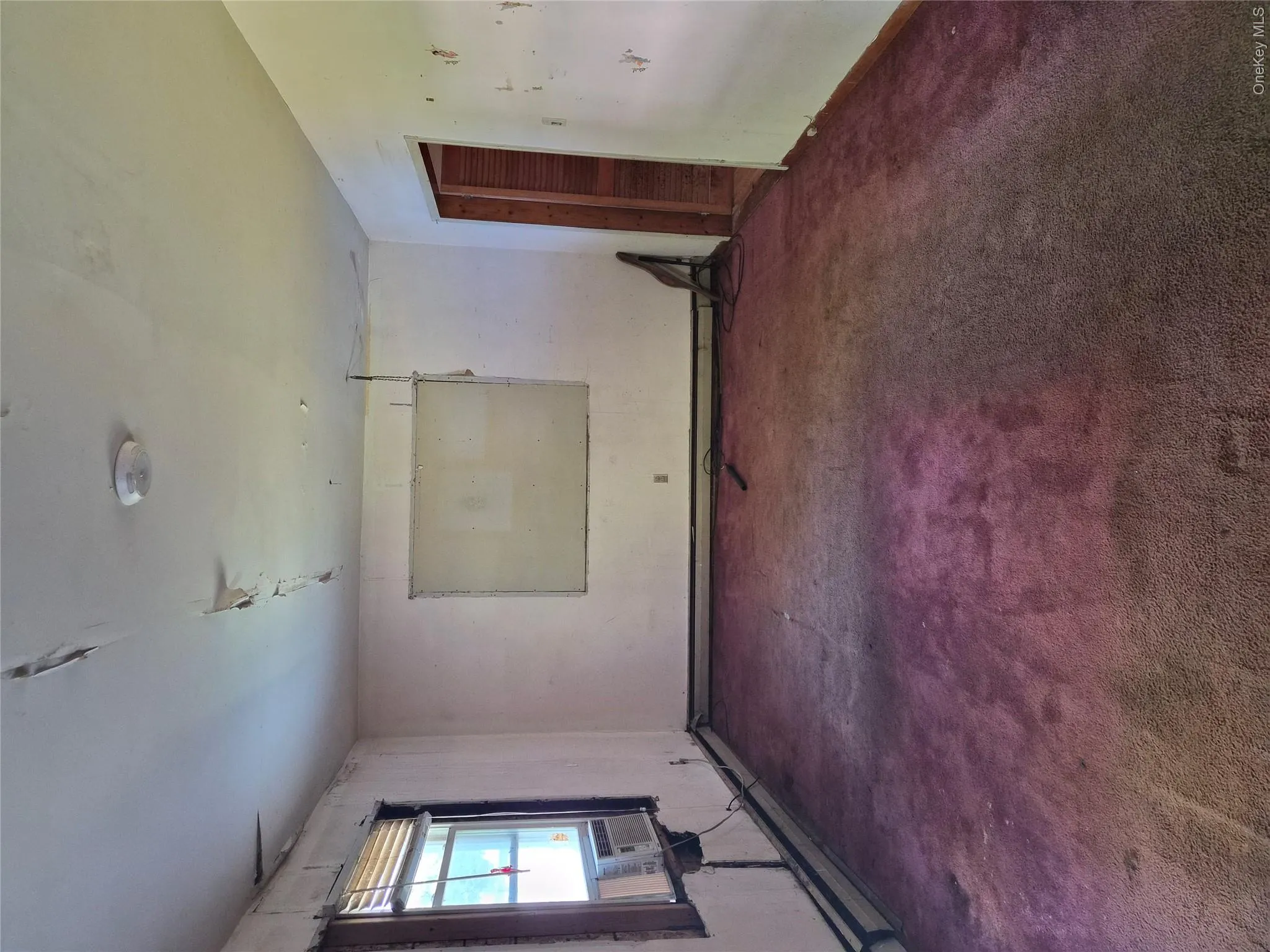 Living Room with two windows and one that had been covered with sheet rock Living Room with two windows and one that had been covered with sheet rock