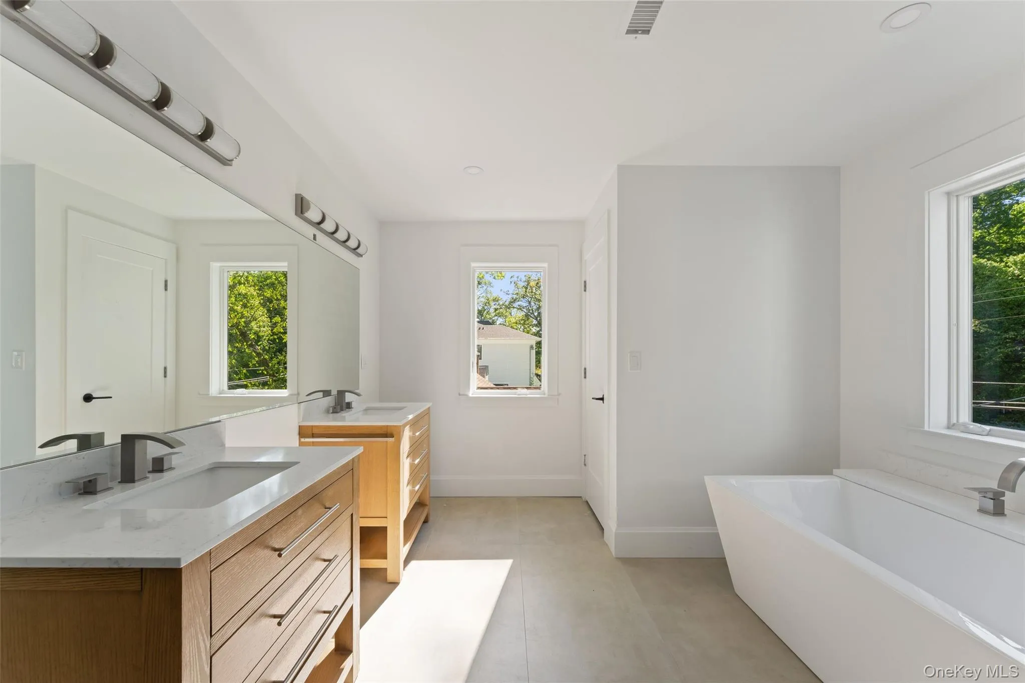 Ensuite primary bathroom with glass enclosed shower, standalone soaking tub, double vanities and separate toilet closet. Ensuite primary bathroom with glass enclosed shower, standalone soaking tub, double vanities and separate toilet closet.