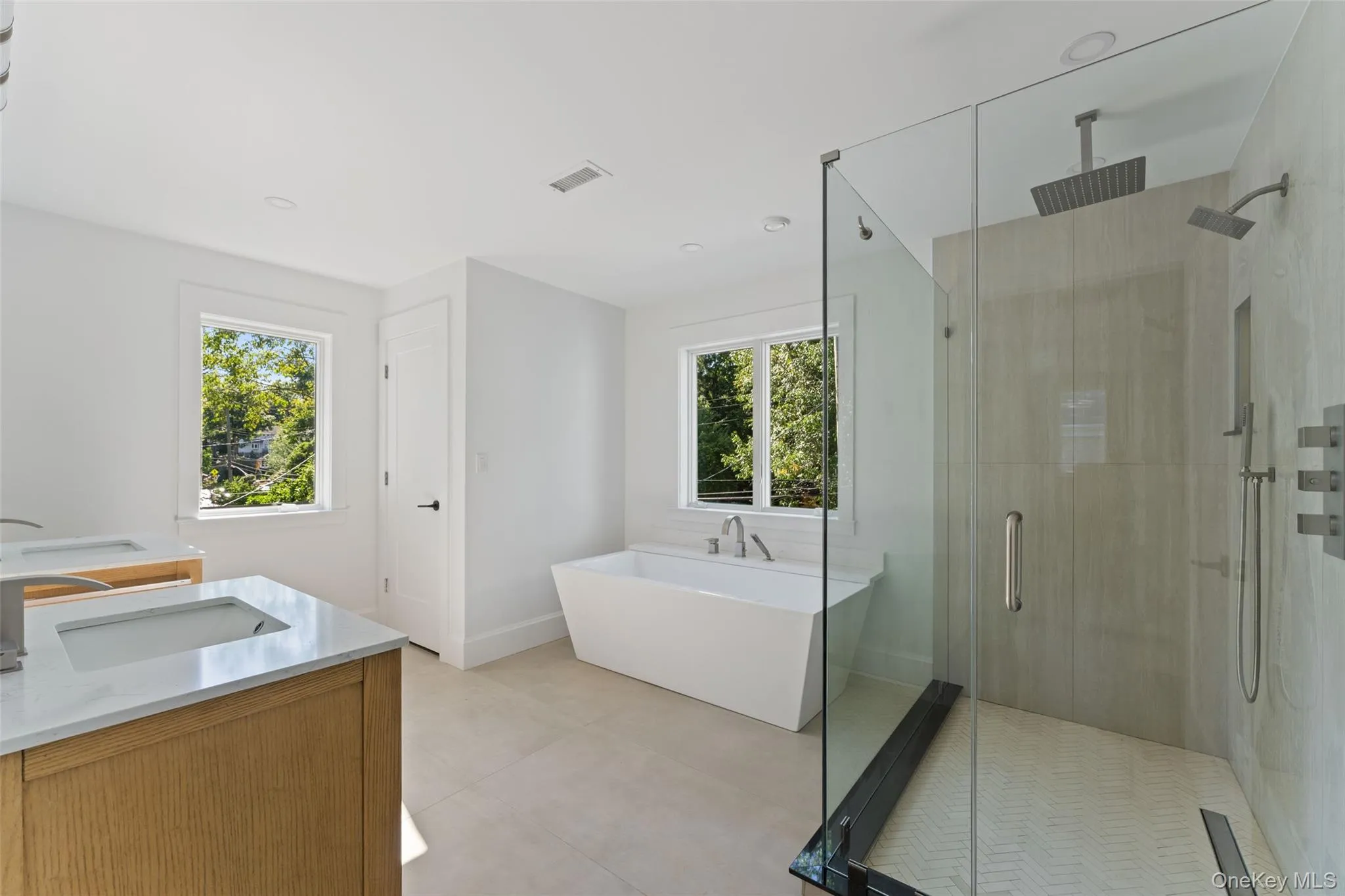 Ensuite primary bathroom with glass enclosed shower, standalone soaking tub, double vanities and separate toilet closet. Ensuite primary bathroom with glass enclosed shower, standalone soaking tub, double vanities and separate toilet closet.