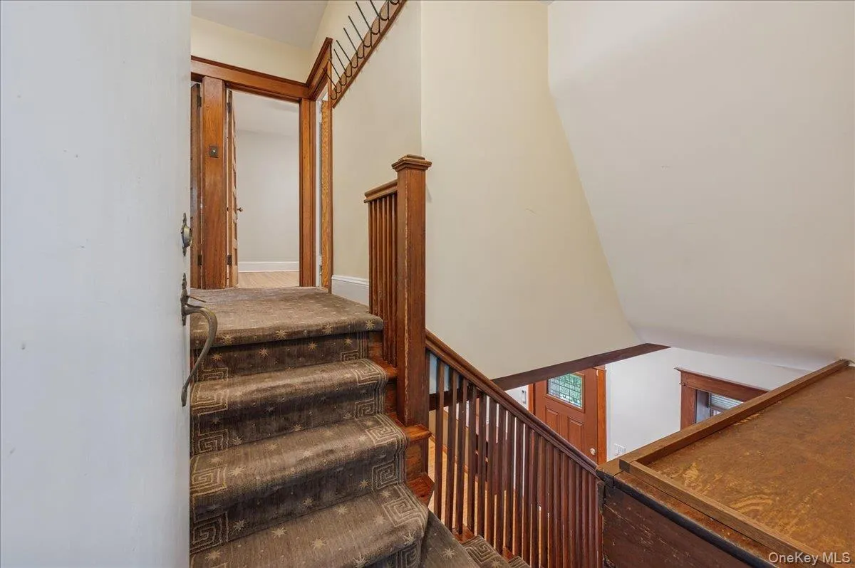 Stairs to main floor bedrooms and den / office Stairs to main floor bedrooms and den / office