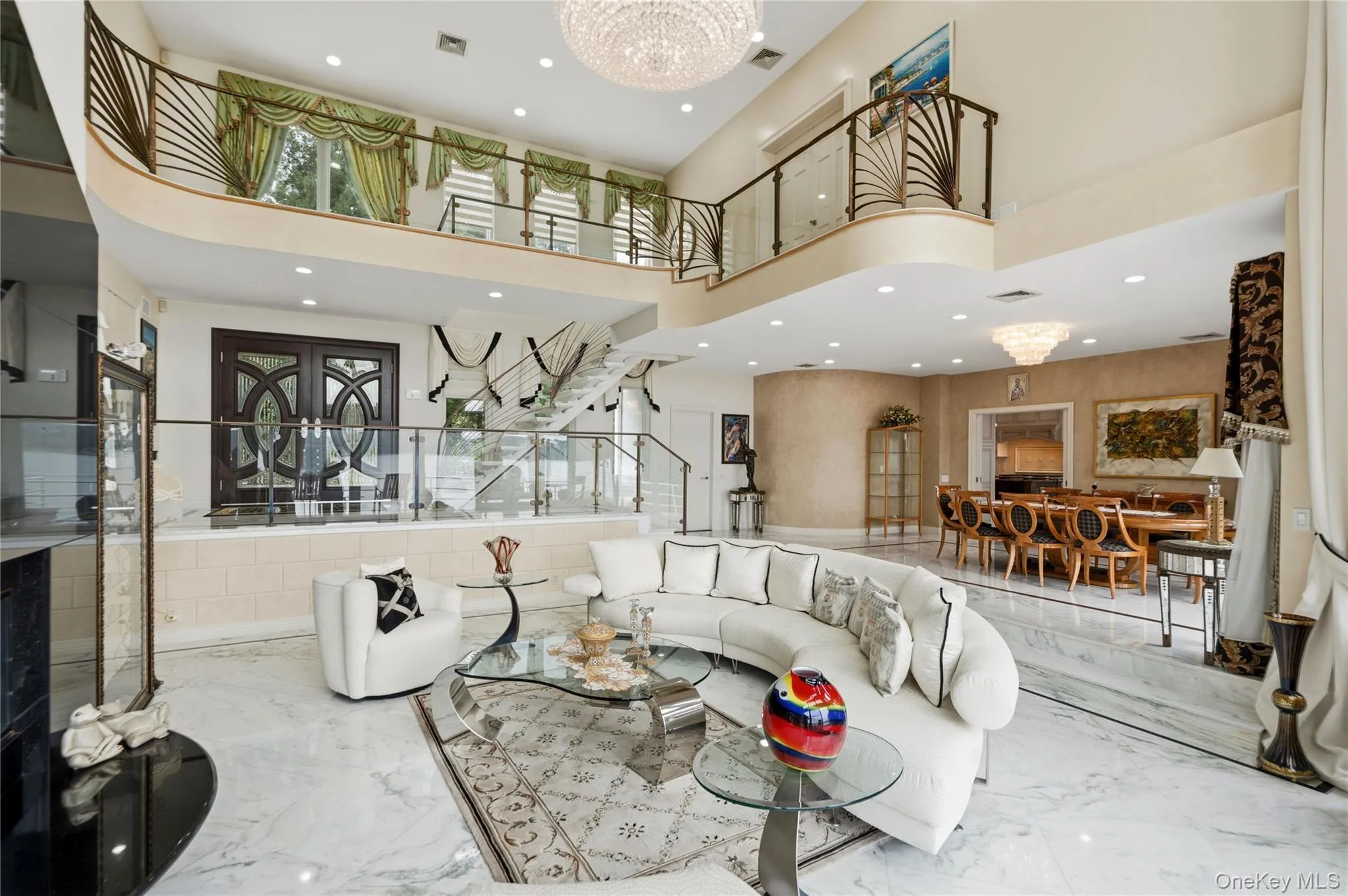 Great room, marble floating staircase, double door entry and custom railings Great room, marble floating staircase, double door entry and custom railings