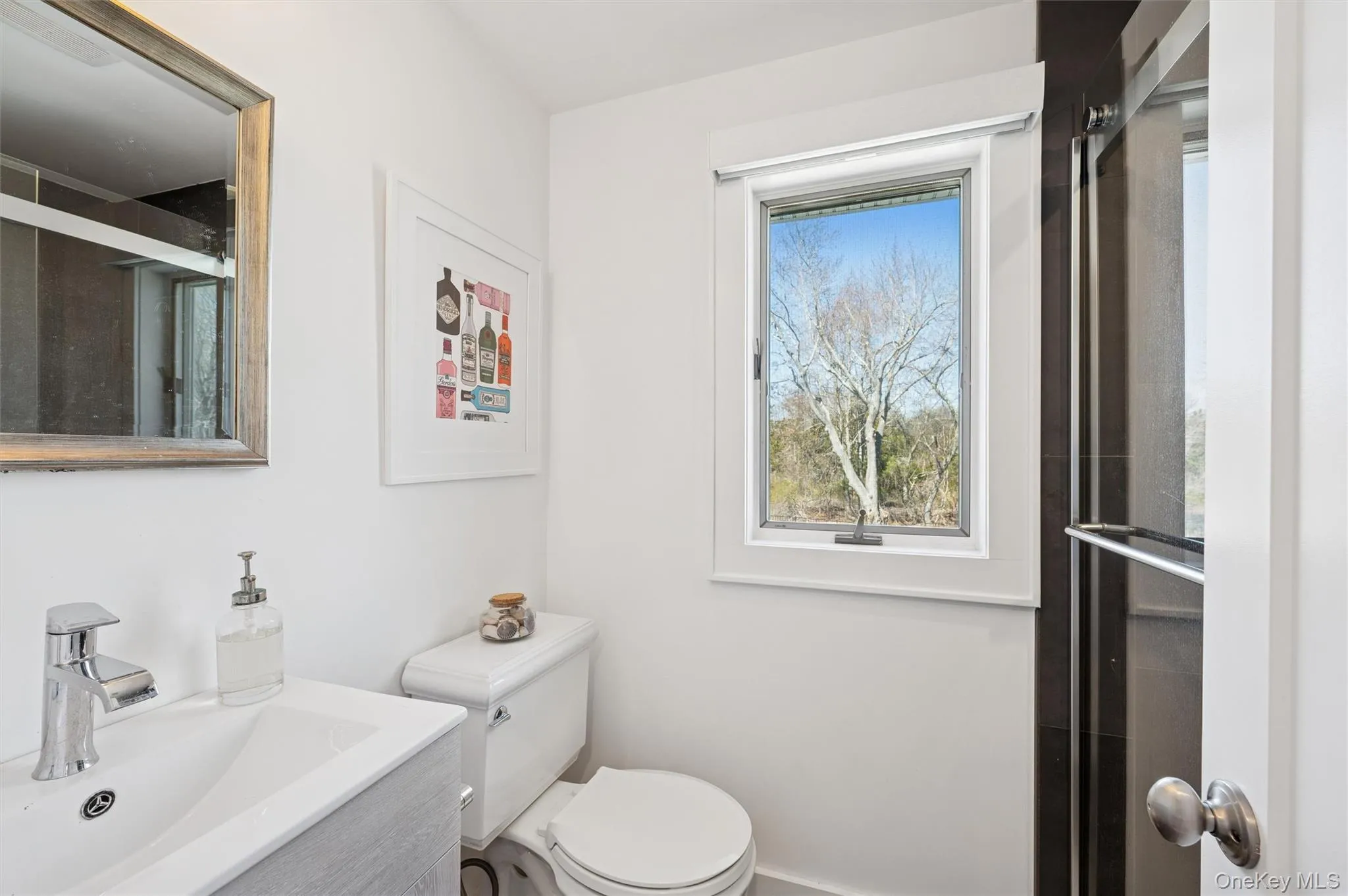 Bathroom featuring toilet and a sink Bathroom featuring toilet and a sink