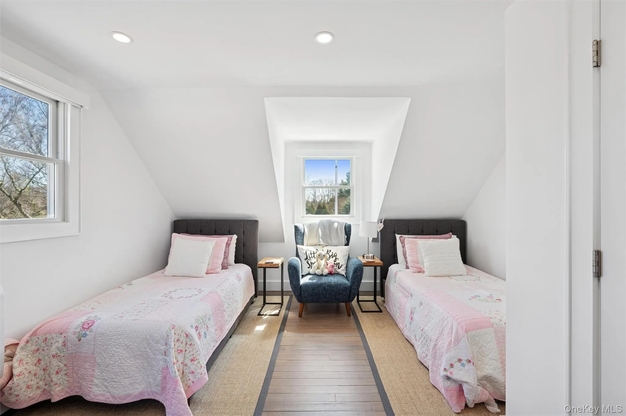 Bedroom with wood-type flooring, multiple windows, vaulted ceiling, and recessed lighting Bedroom with wood-type flooring, multiple windows, vaulted ceiling, and recessed lighting
